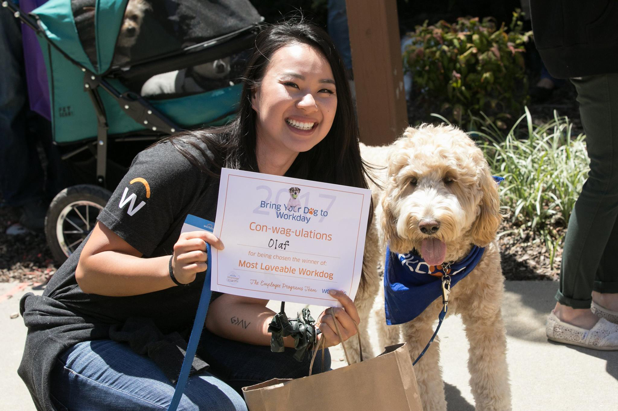 Workday employee with her dog receiving a certificate