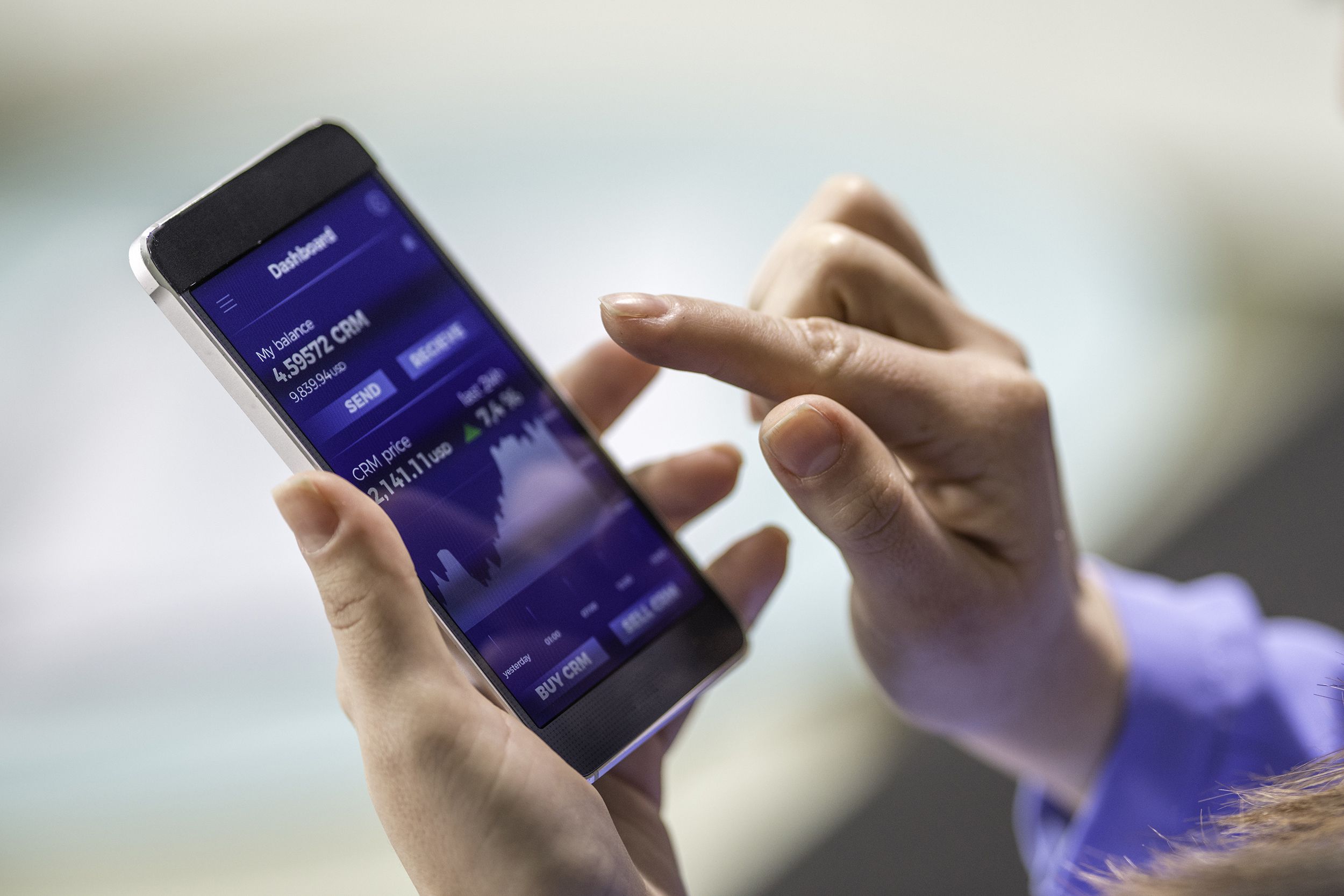woman buying cryptocurrency through mobile phone app