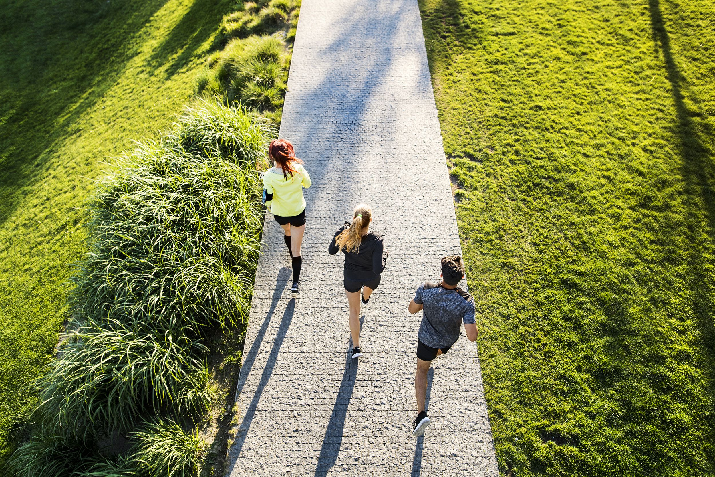 three people jogging in the park, seen from above