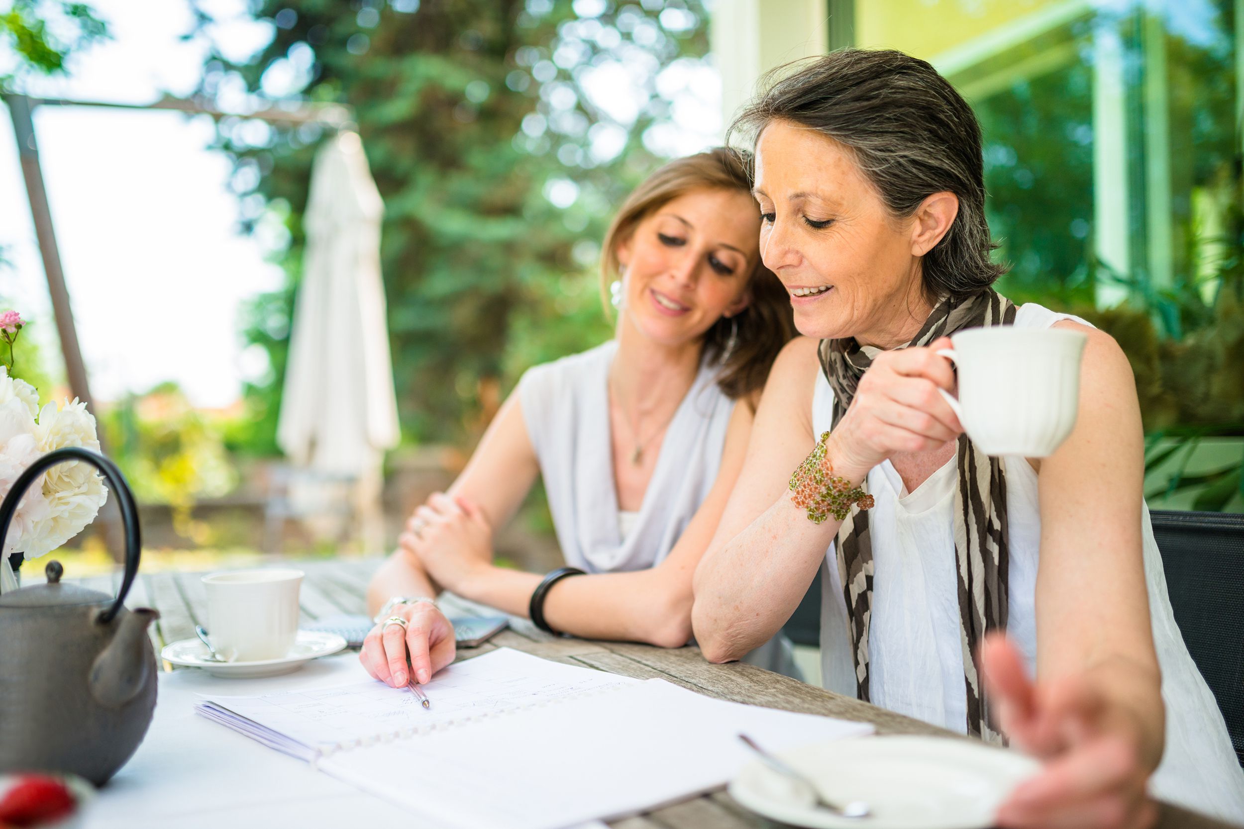 mother and daughter take a tea together