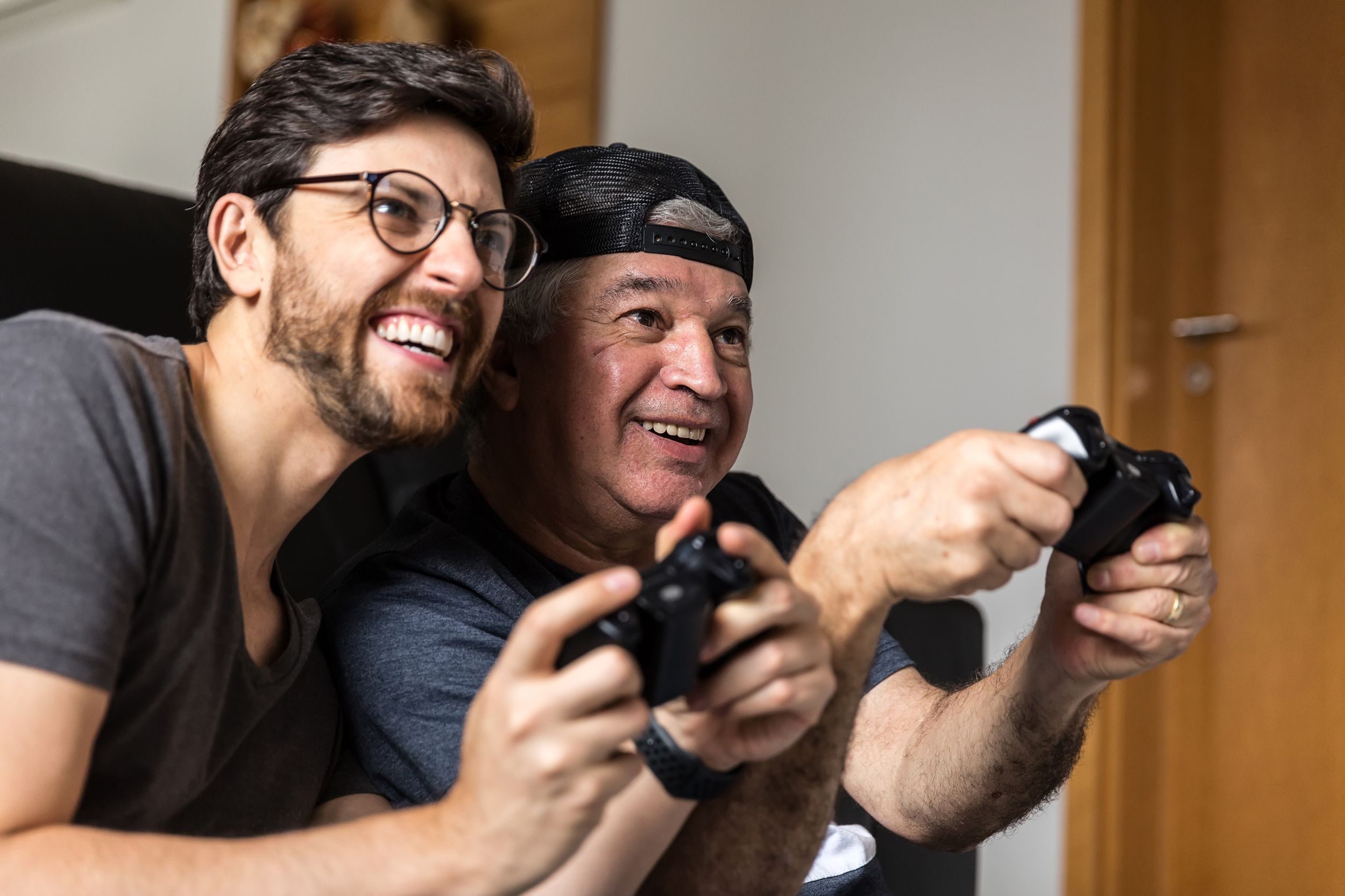 father and adult son playing video games together