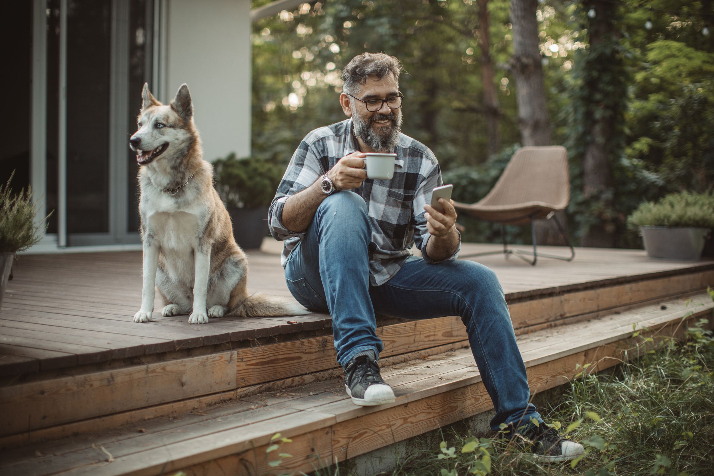 middle-aged father outside holding phone