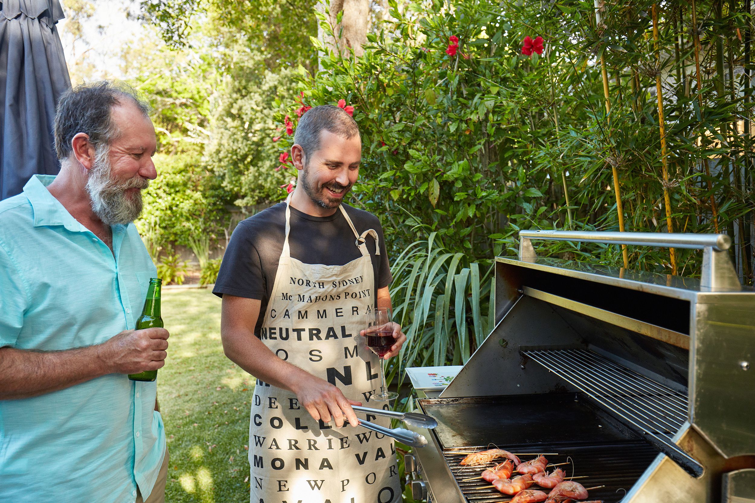 Australian father and son preparing barbecue in the summer