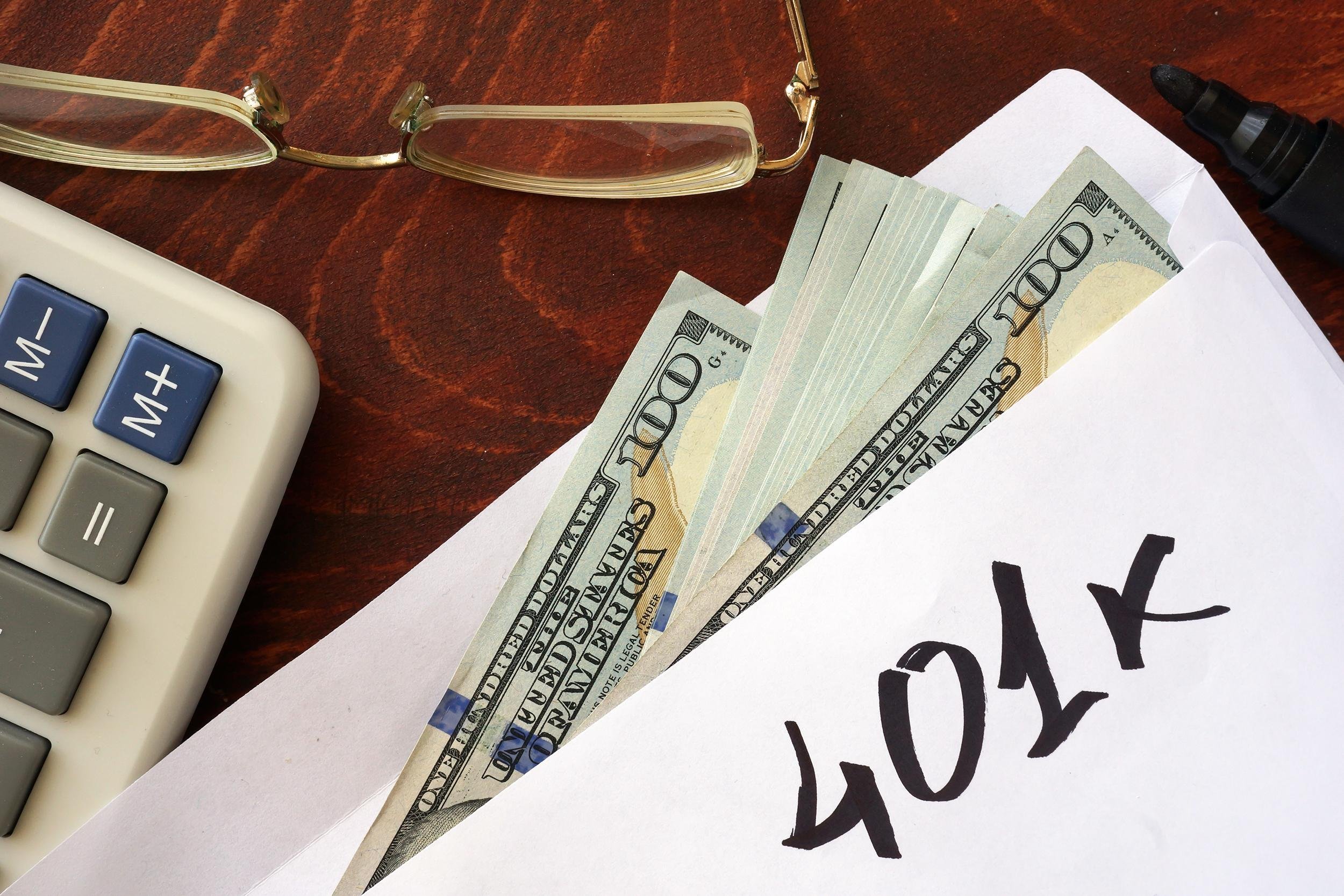401k written on an envelope with dollars