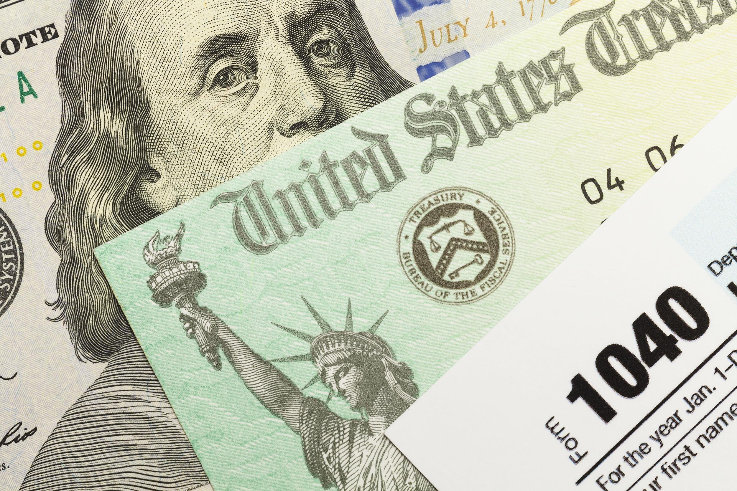 1040 tax form with refund check and cash
