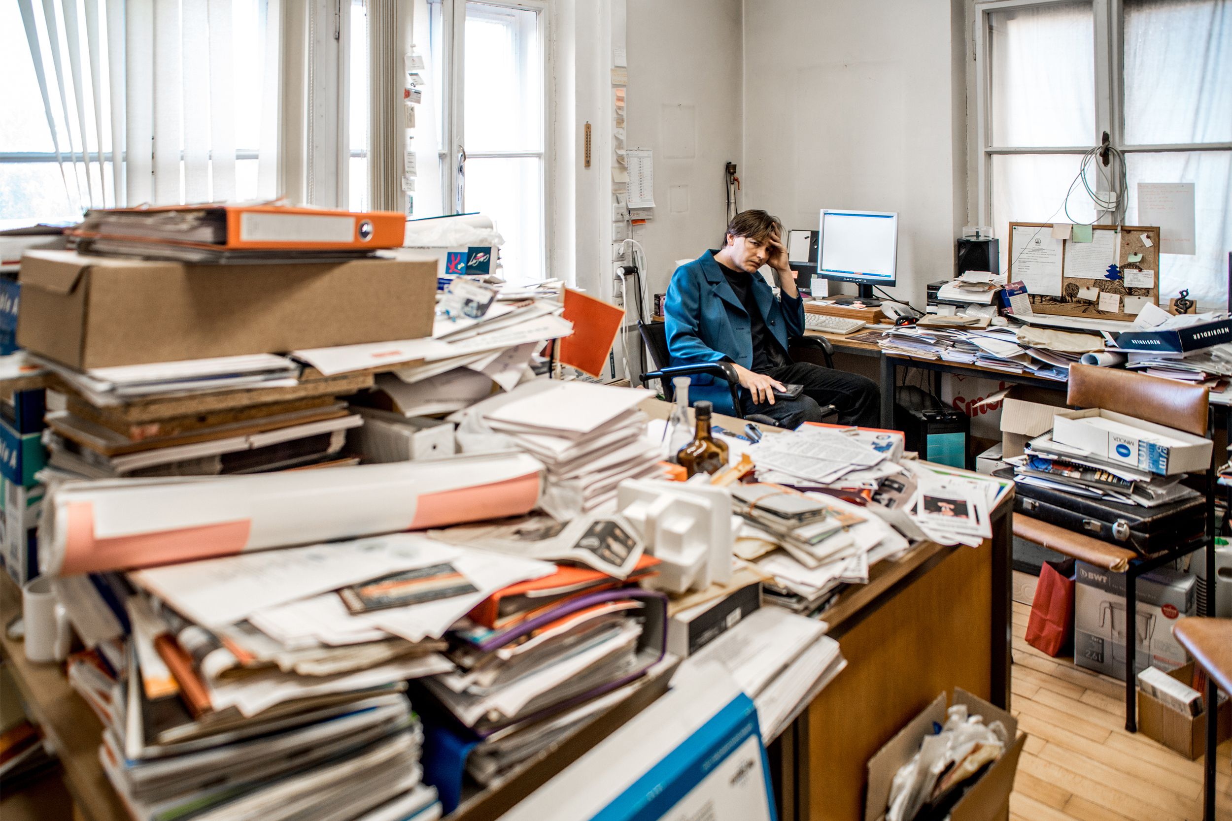 Man sitting in cluttered office