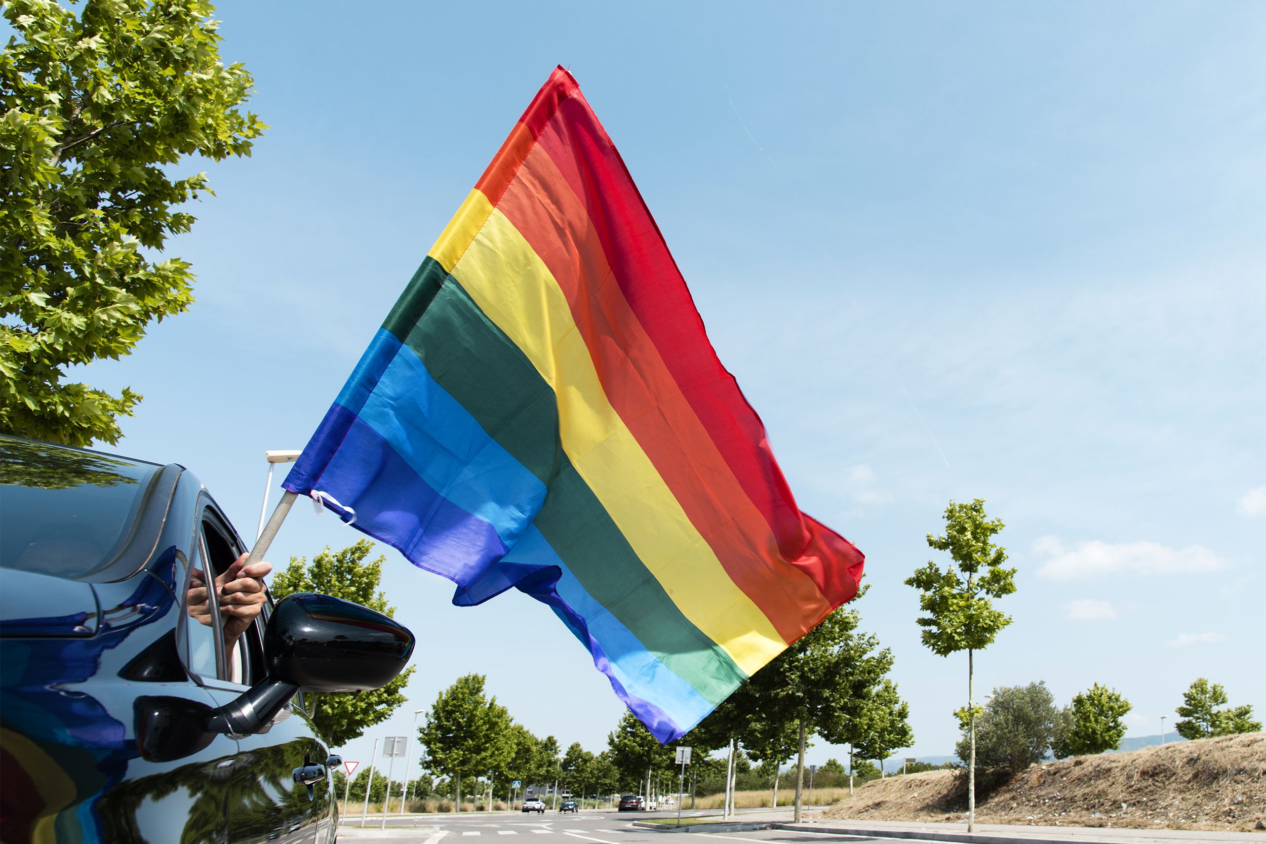 Rainbow flag in a car