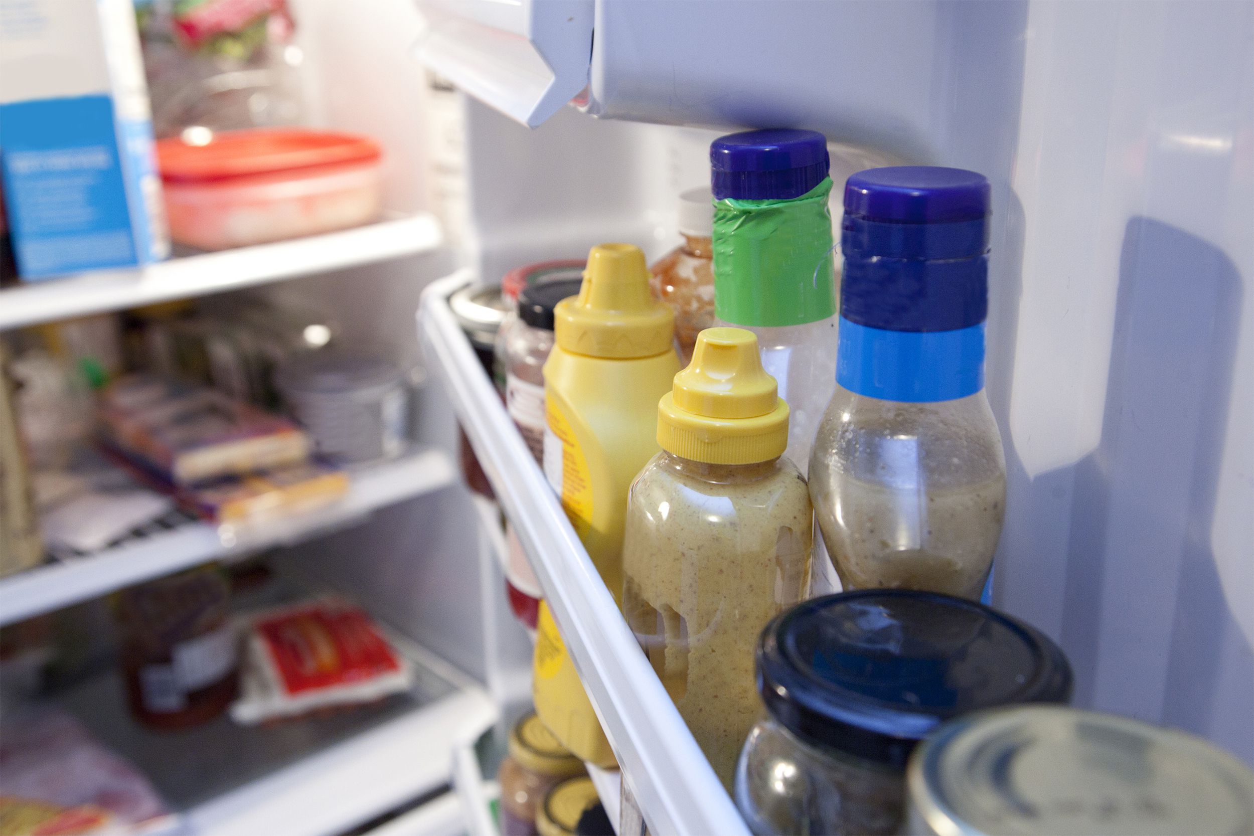 Refrigerator door with condiments