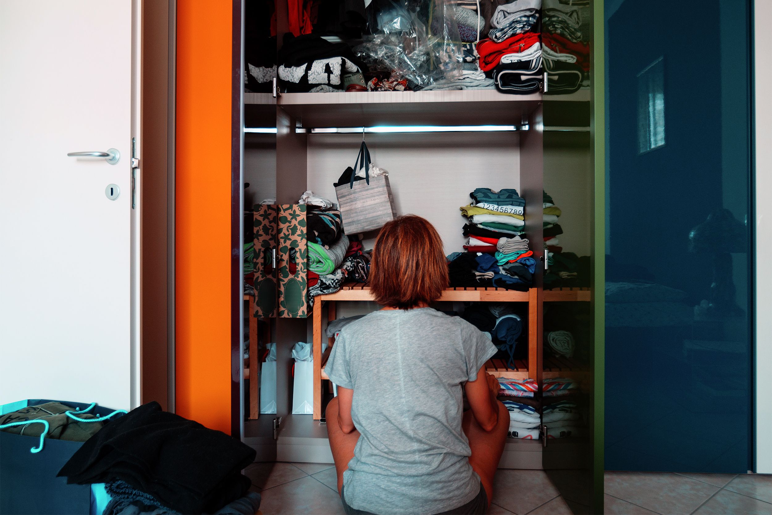 Woman sitting in front of her closet