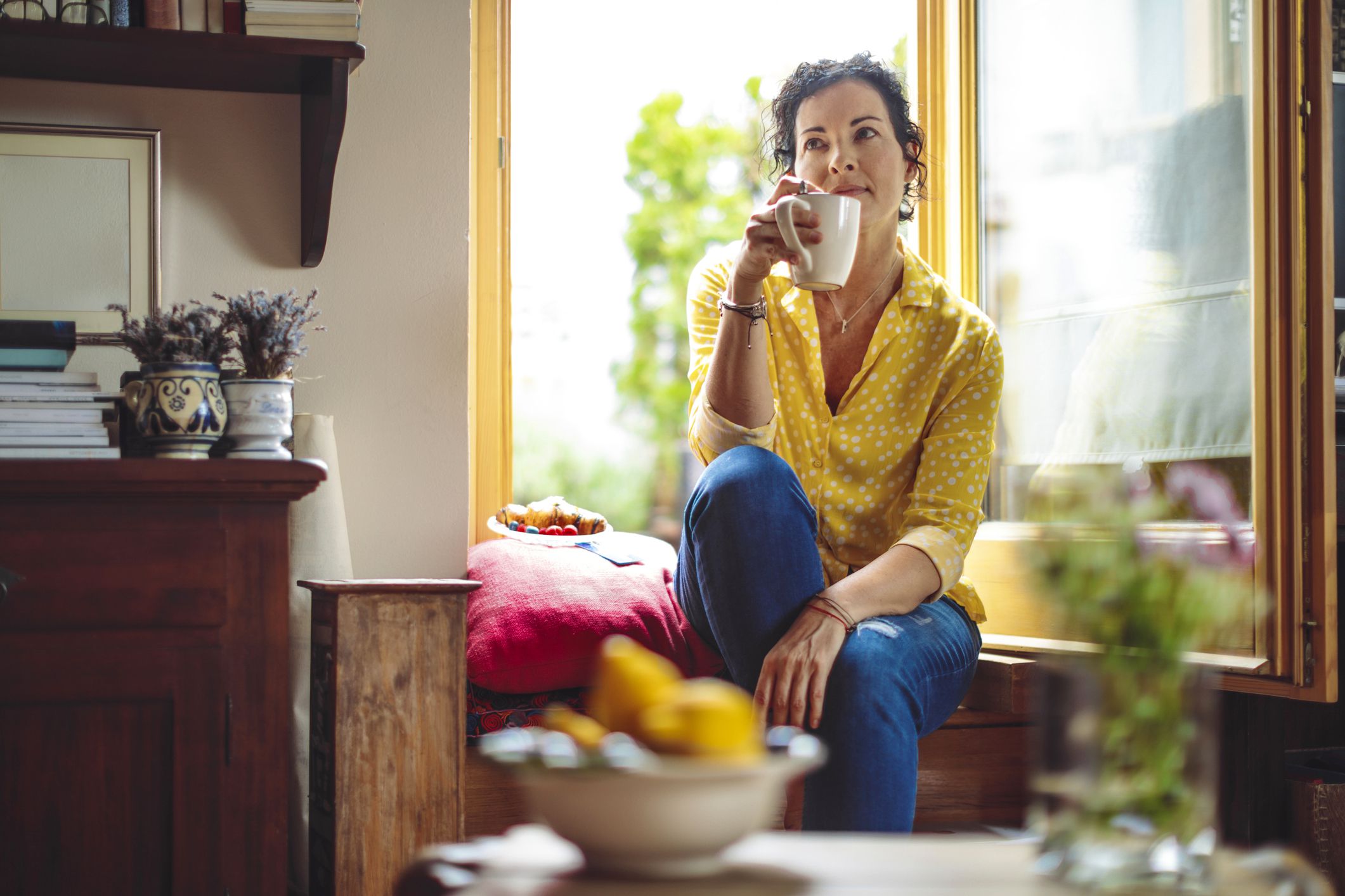 woman reflecting while sipping coffee