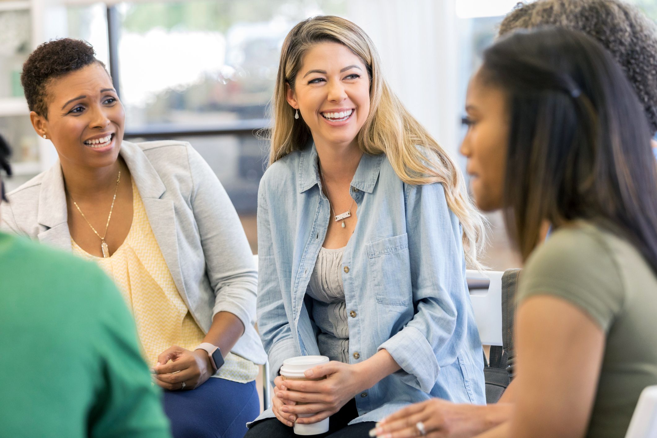 women smiling and laughing at support group