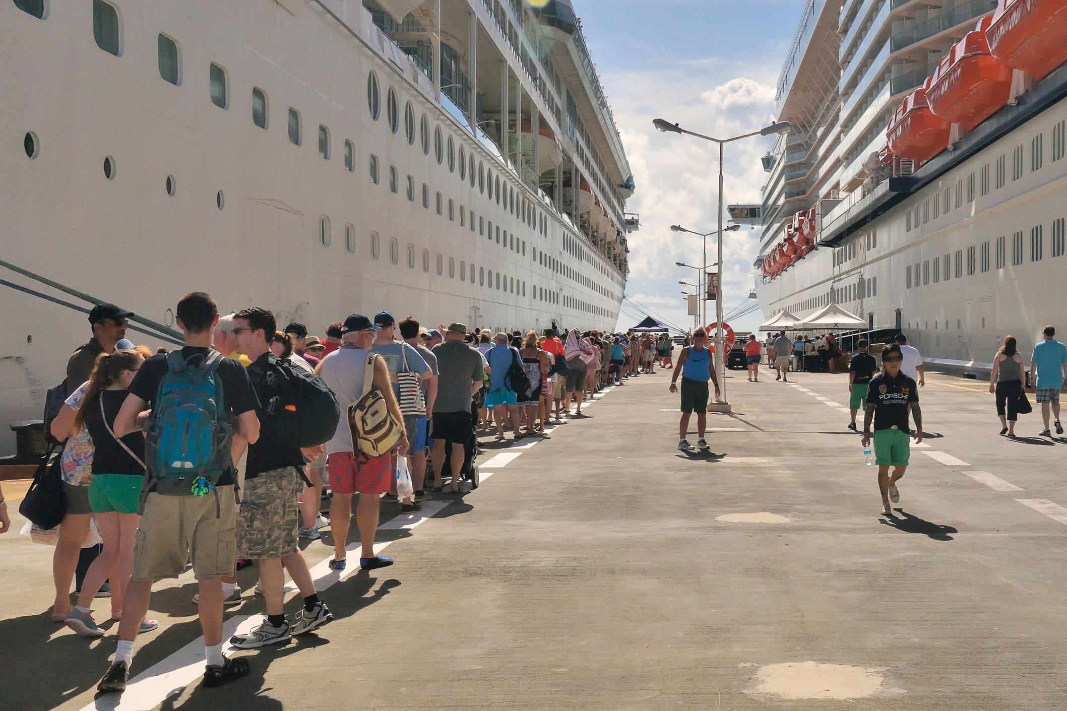 cruise ship passengers waiting in line to board