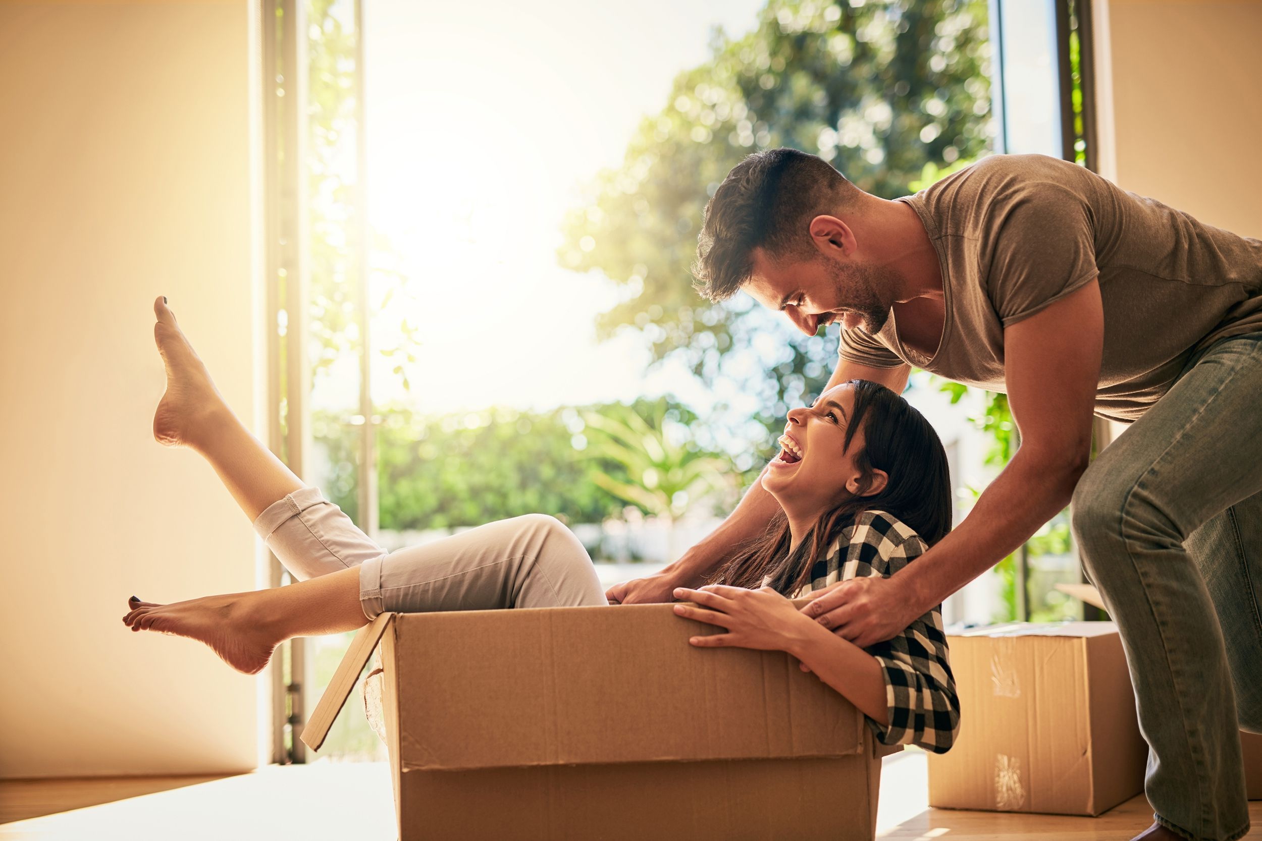 man pushing woman in box while moving in