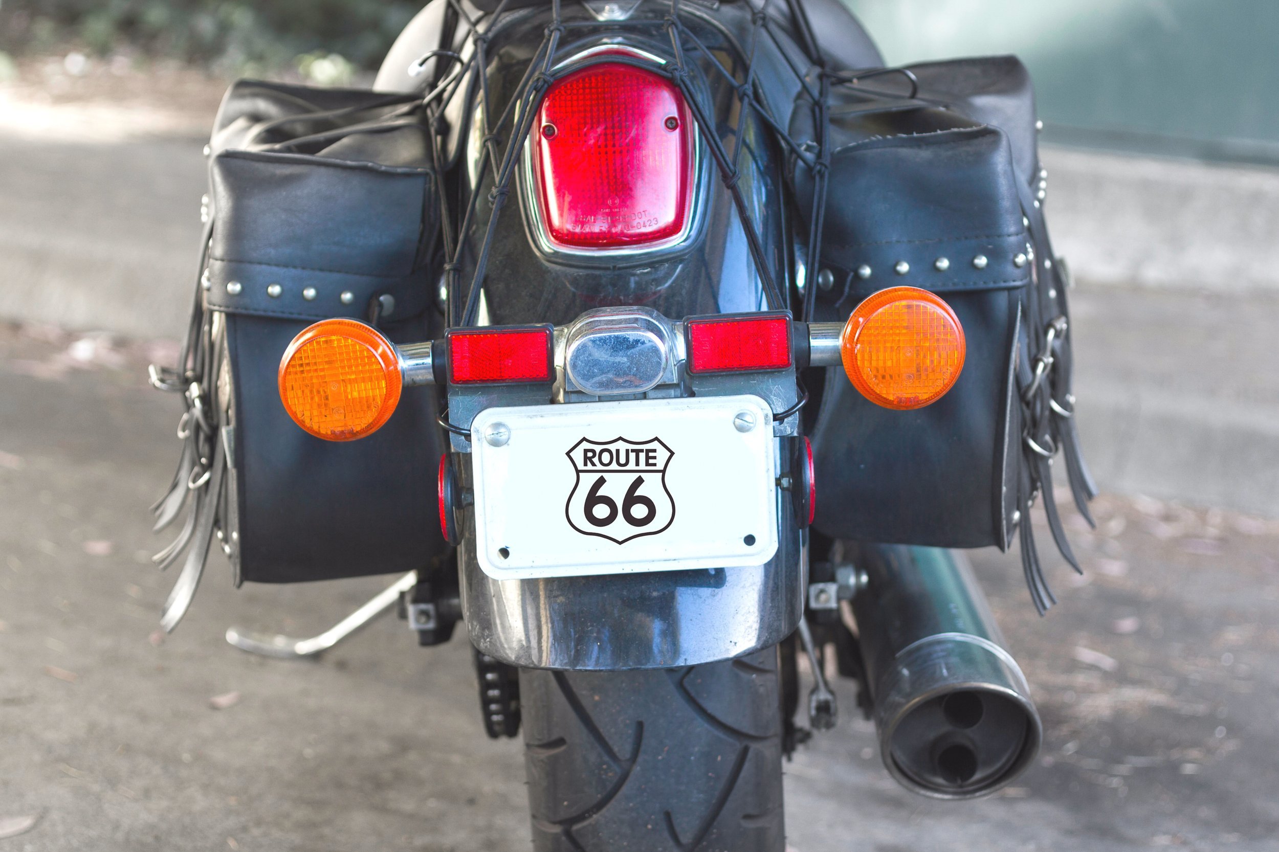 Details of black cruiser motorcycle, rear view.