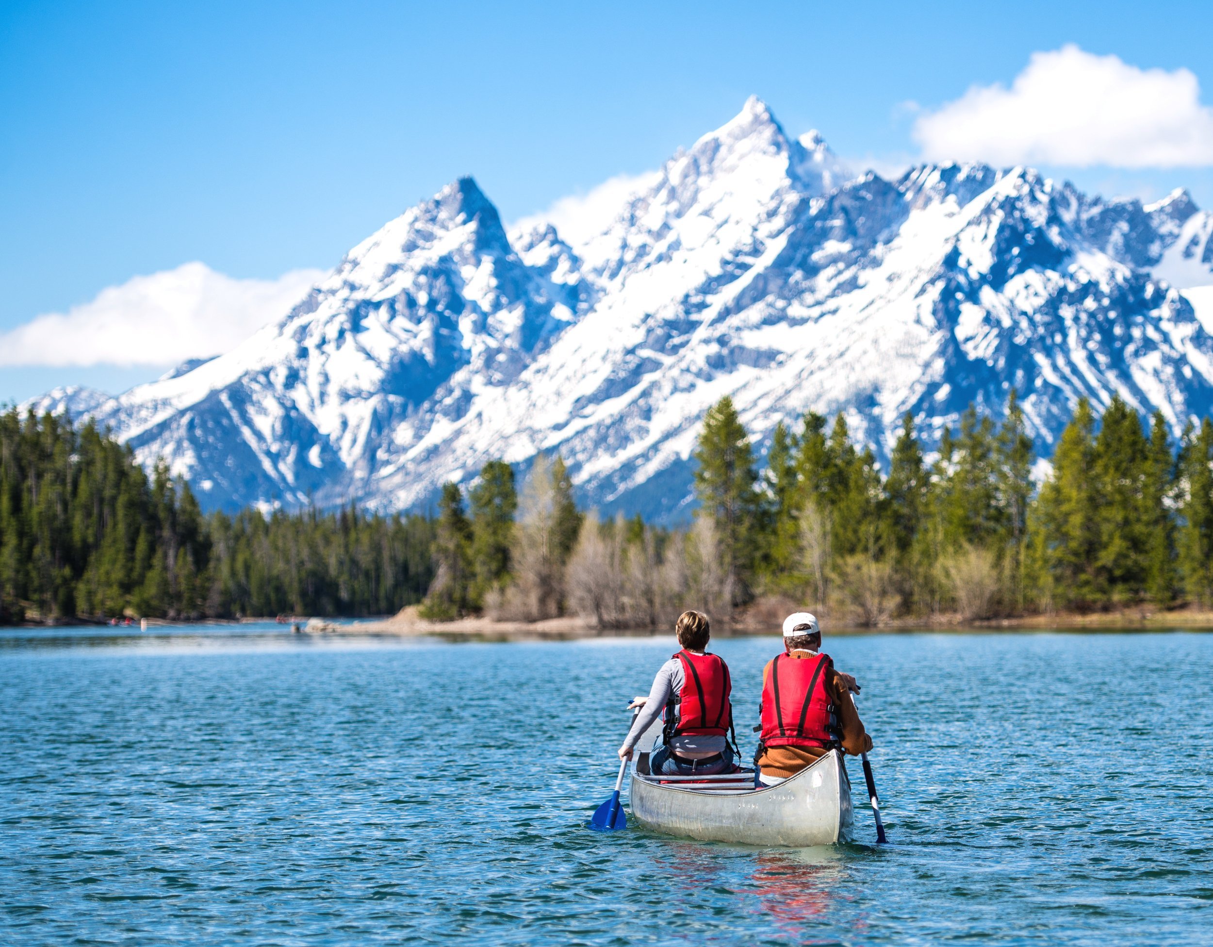 Father and daughter canoeing on Jackson Lake in the Grand Teton National Park.