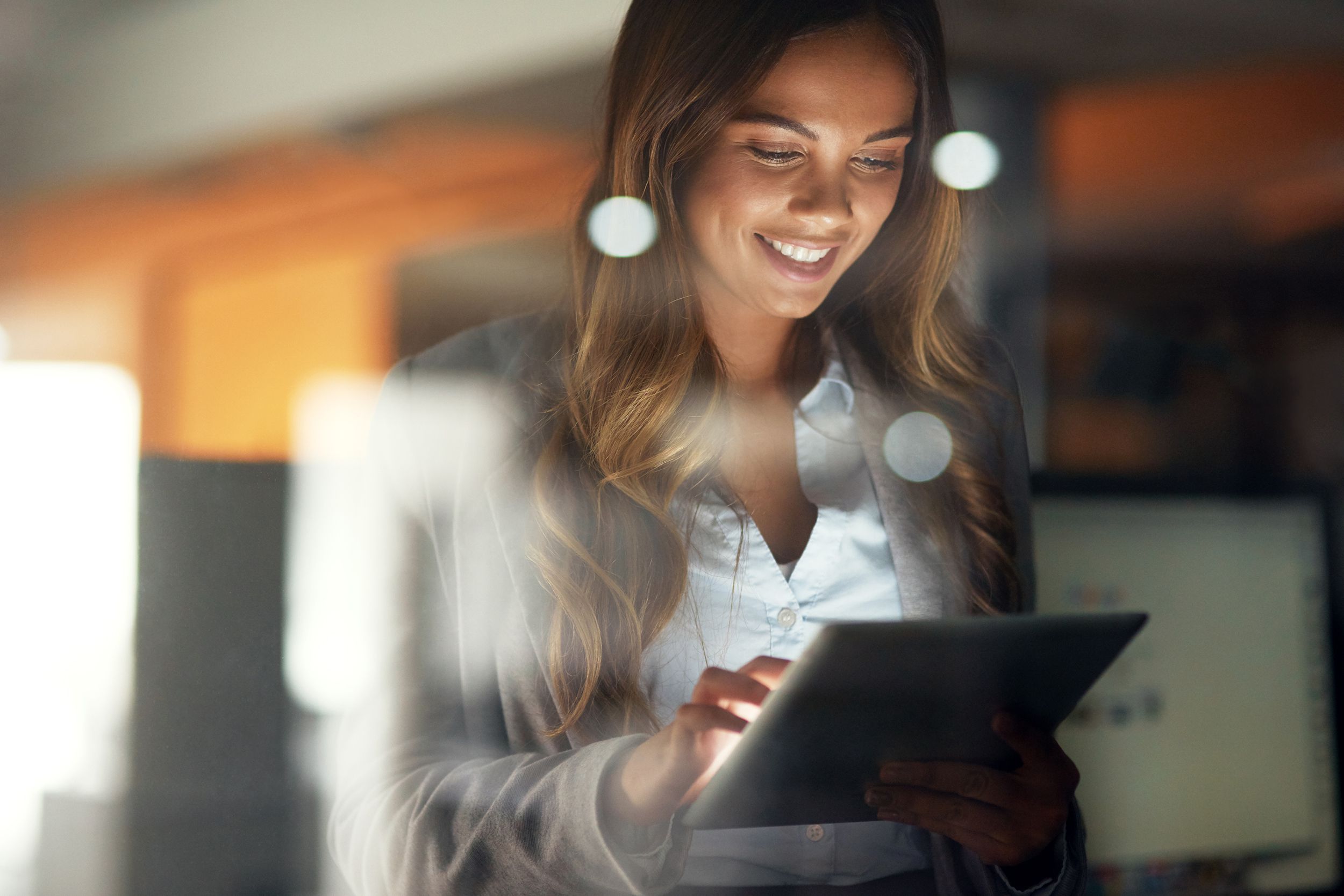 woman on tablet at night in office
