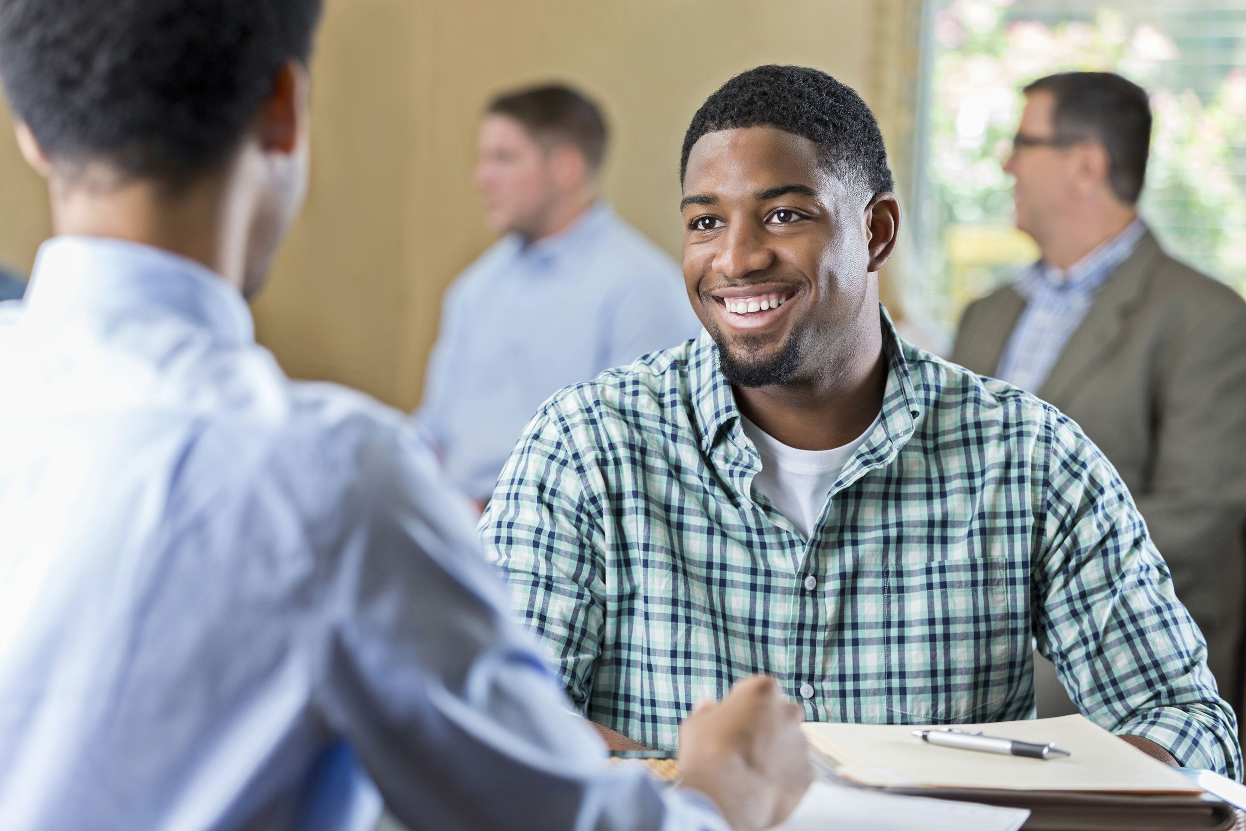 smiling African American young adult at a job interview