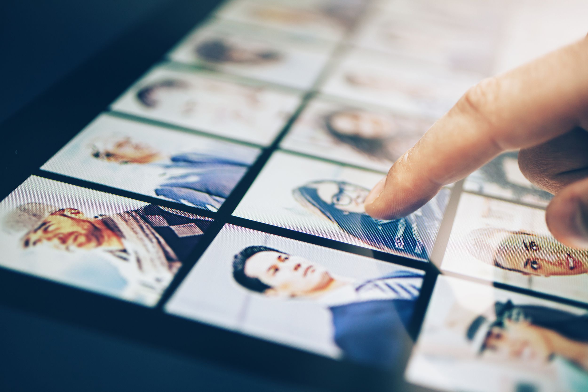 finger on headshot of young woman on tablet
