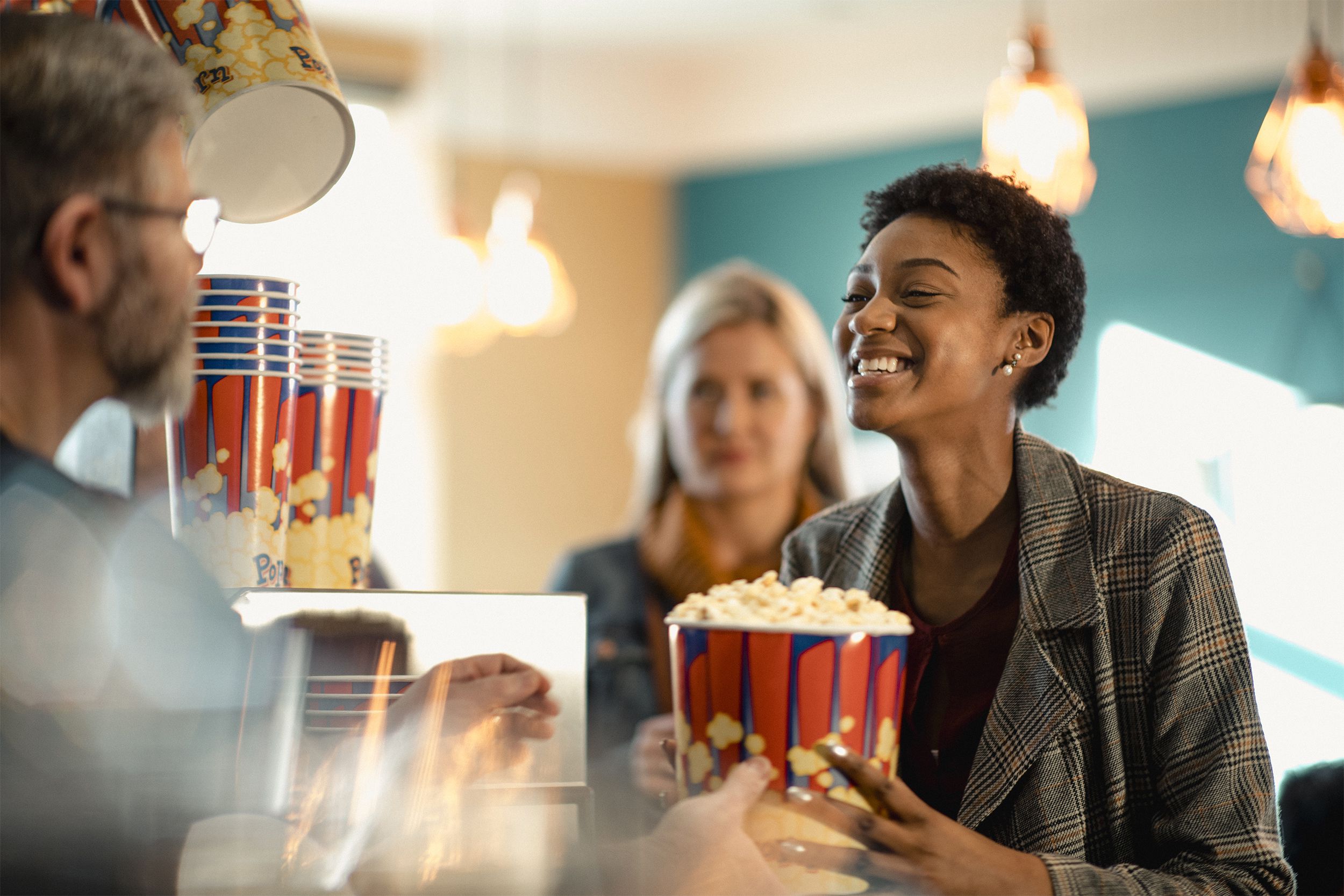 Excited woman getting popcorn at the movie theater