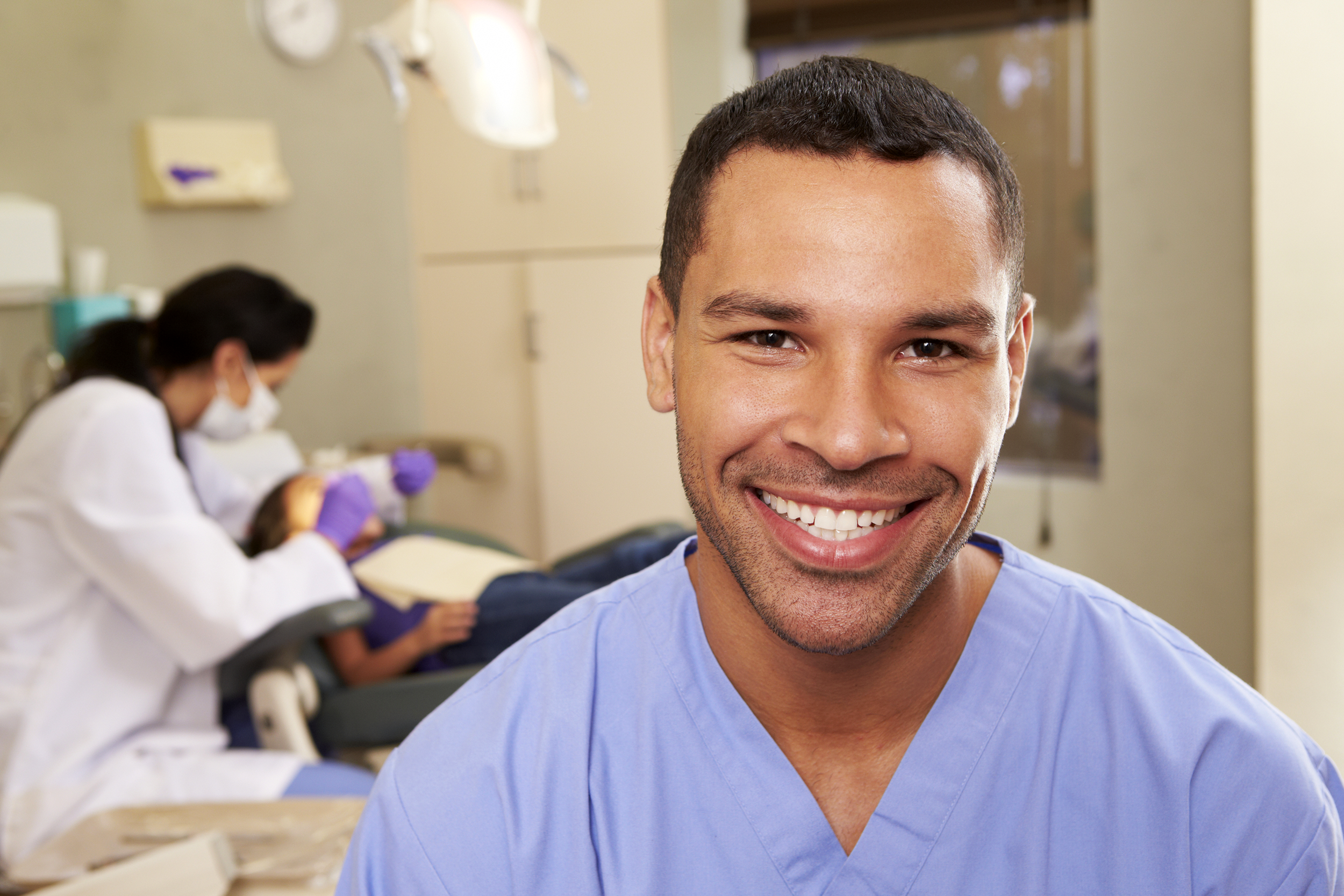 Young male dental assistant