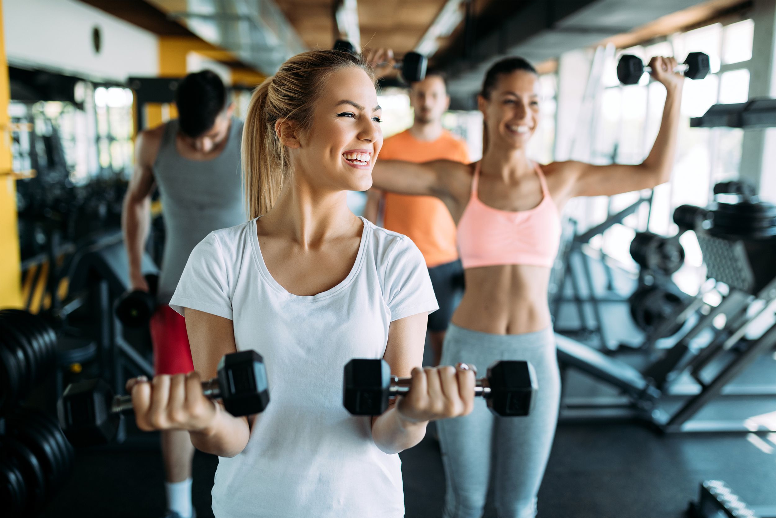 Woman lifting weights in a gym