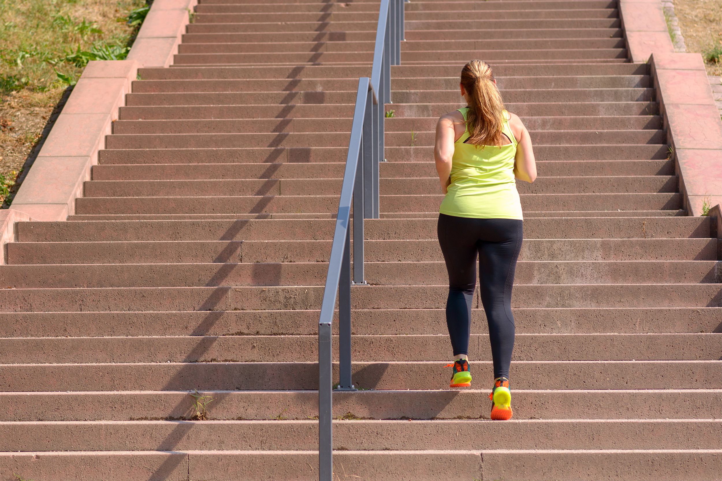 Woman running up stairs outside