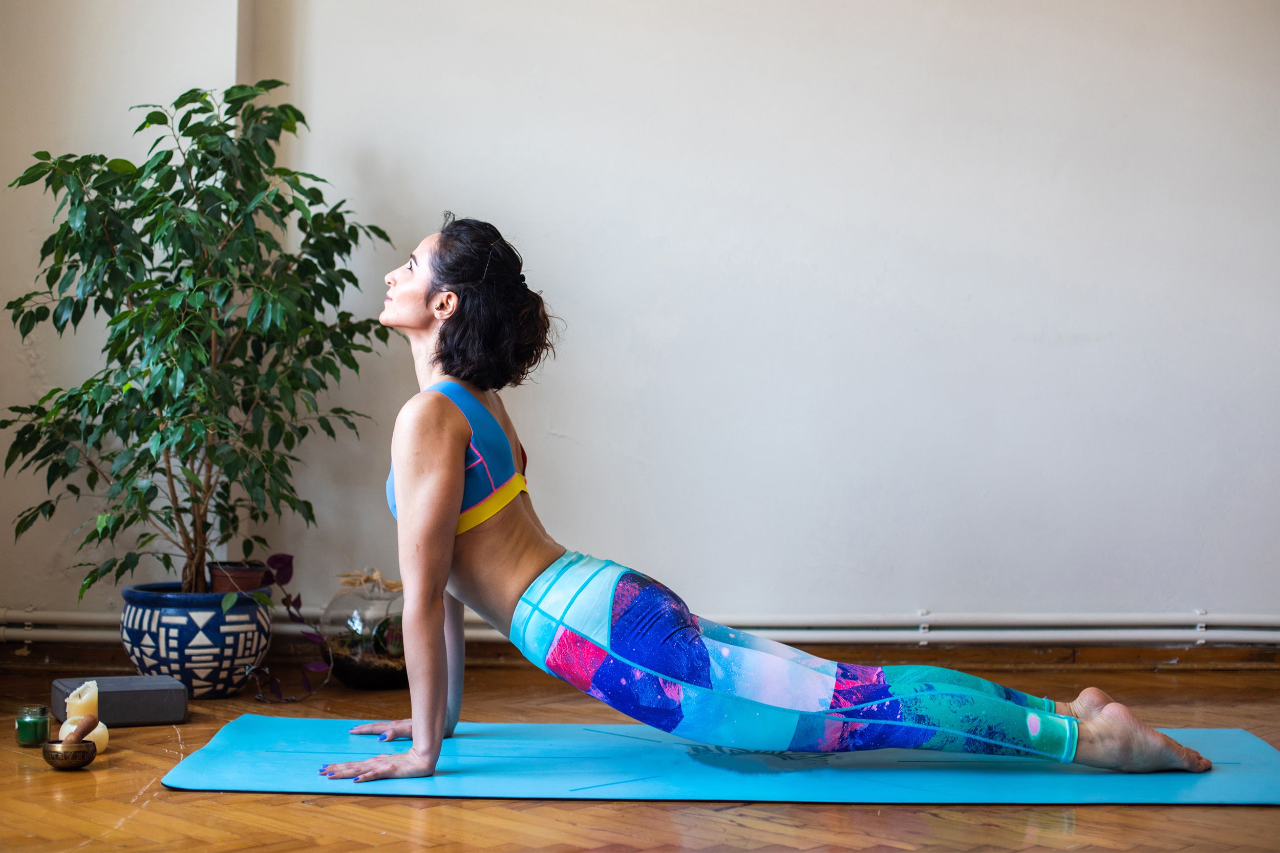 Woman doing sun salutations and yoga in her house