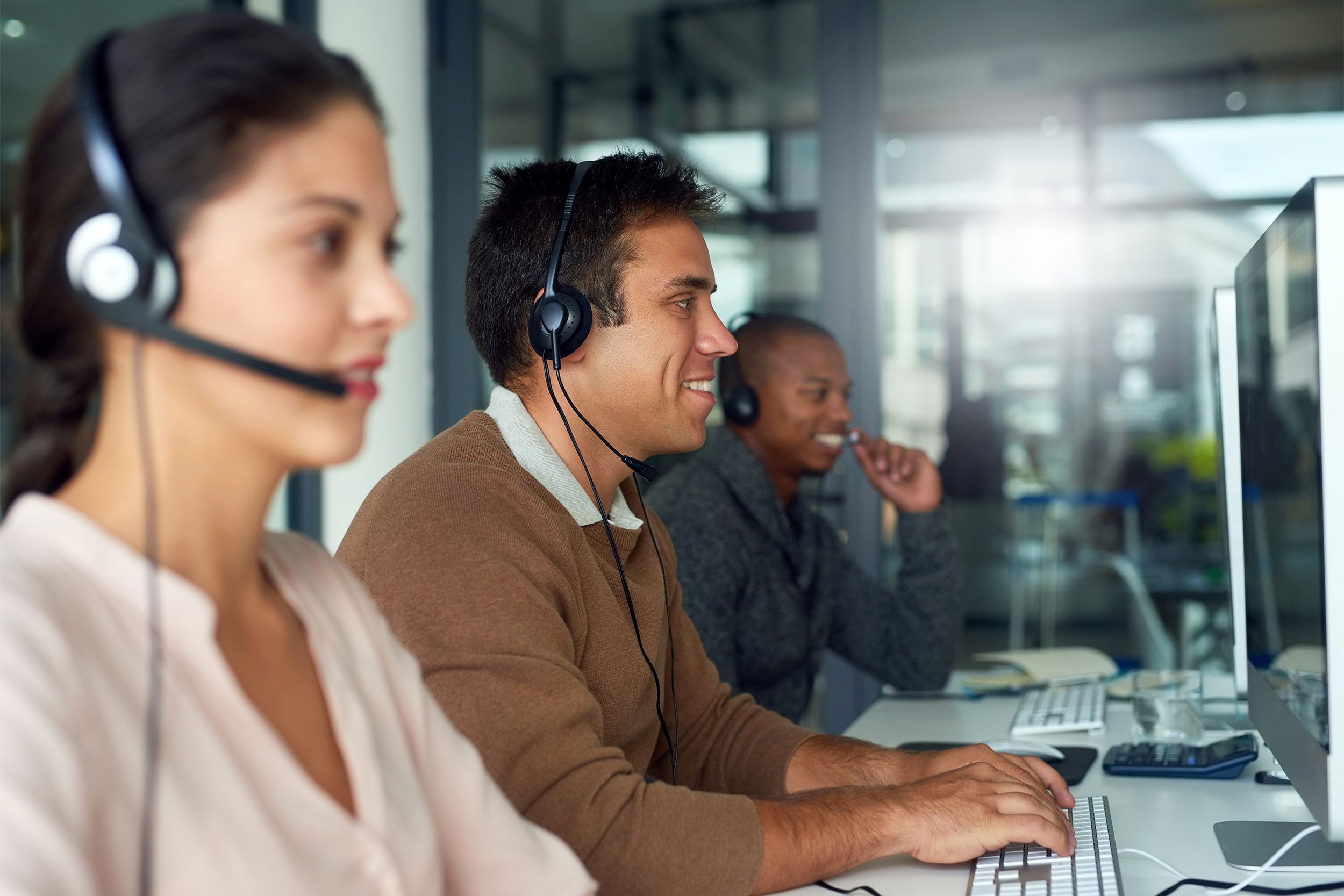 Young men and women working in a call center
