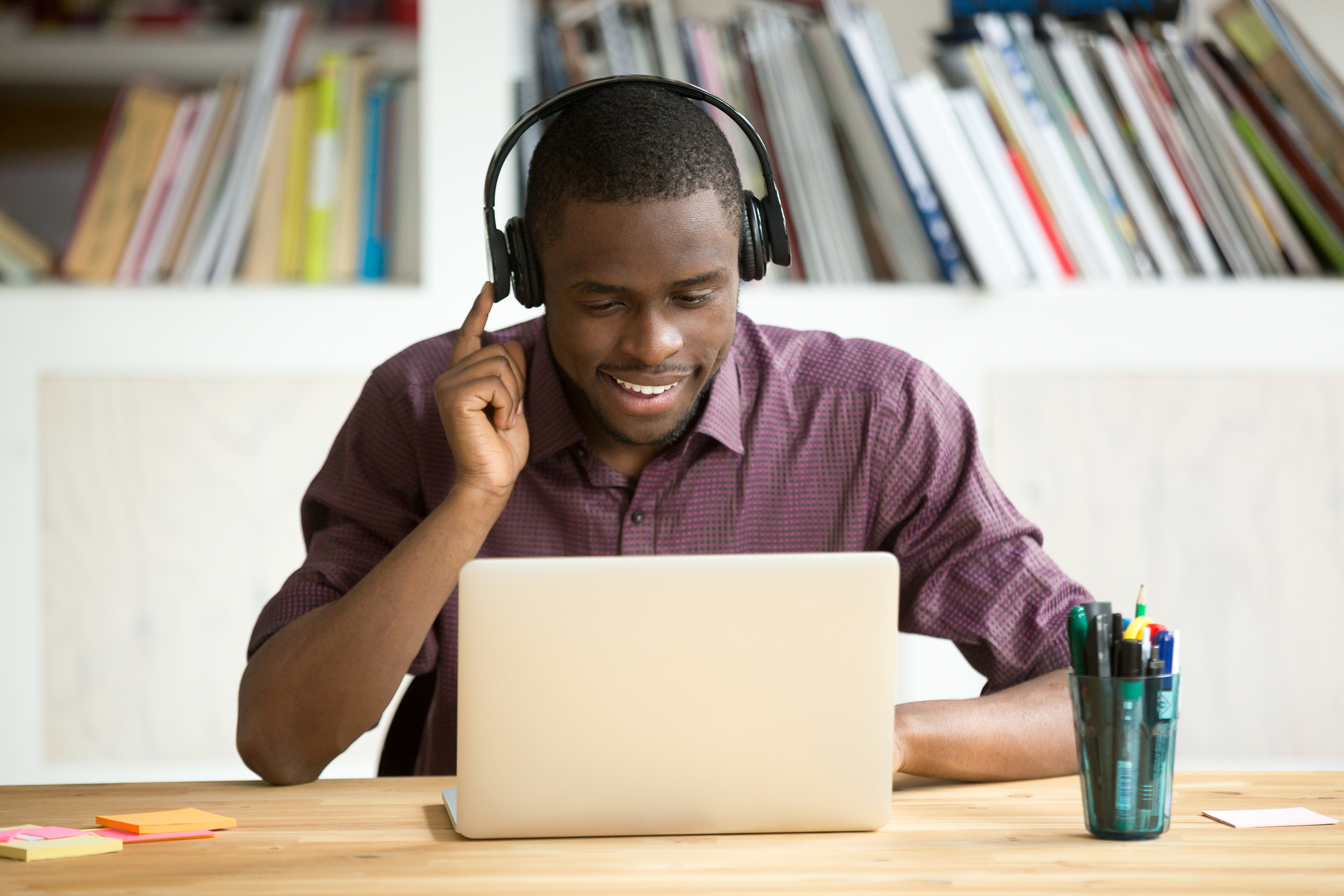 Young man on a laptop wearing headphones
