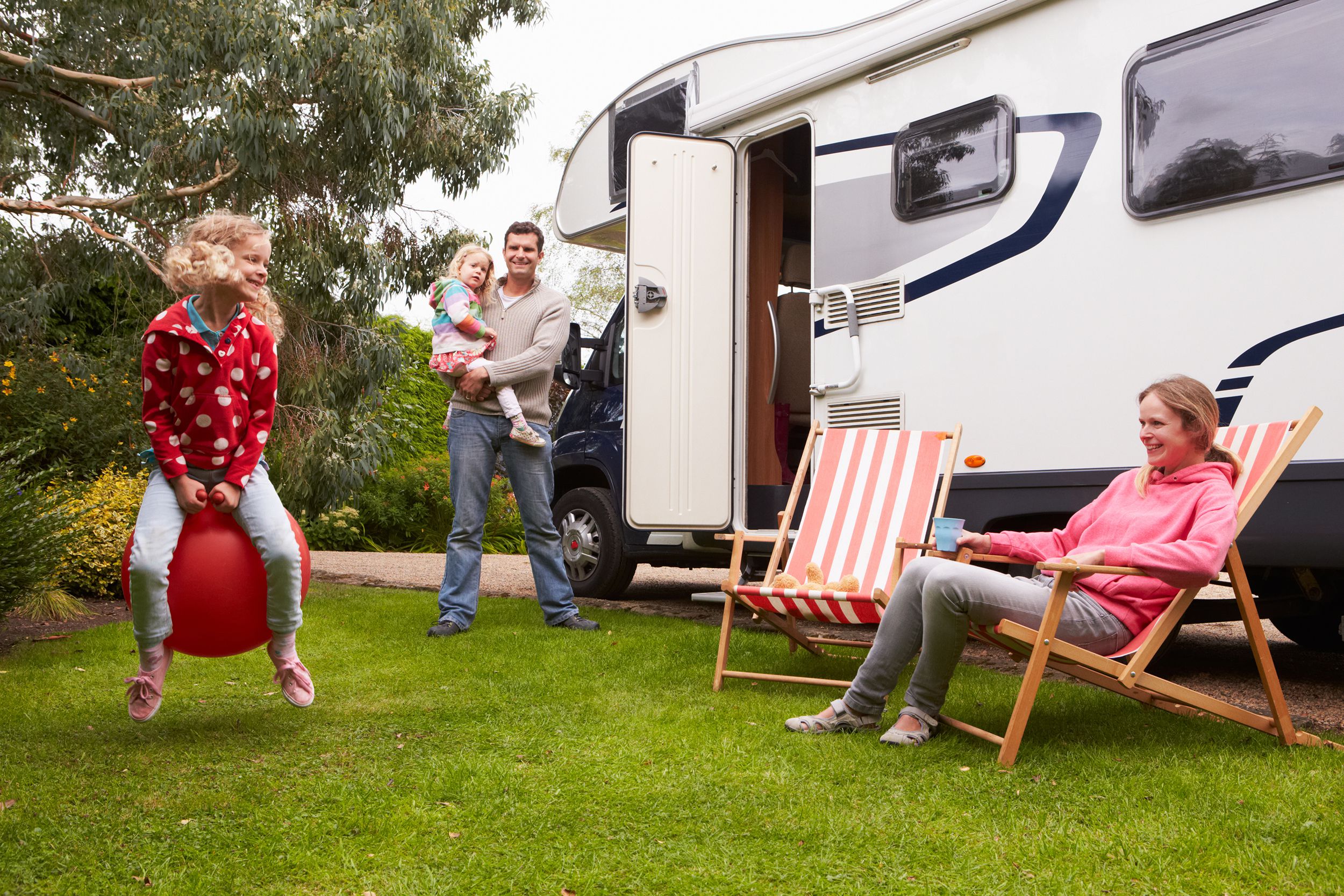 family enjoying camping holiday in camper van