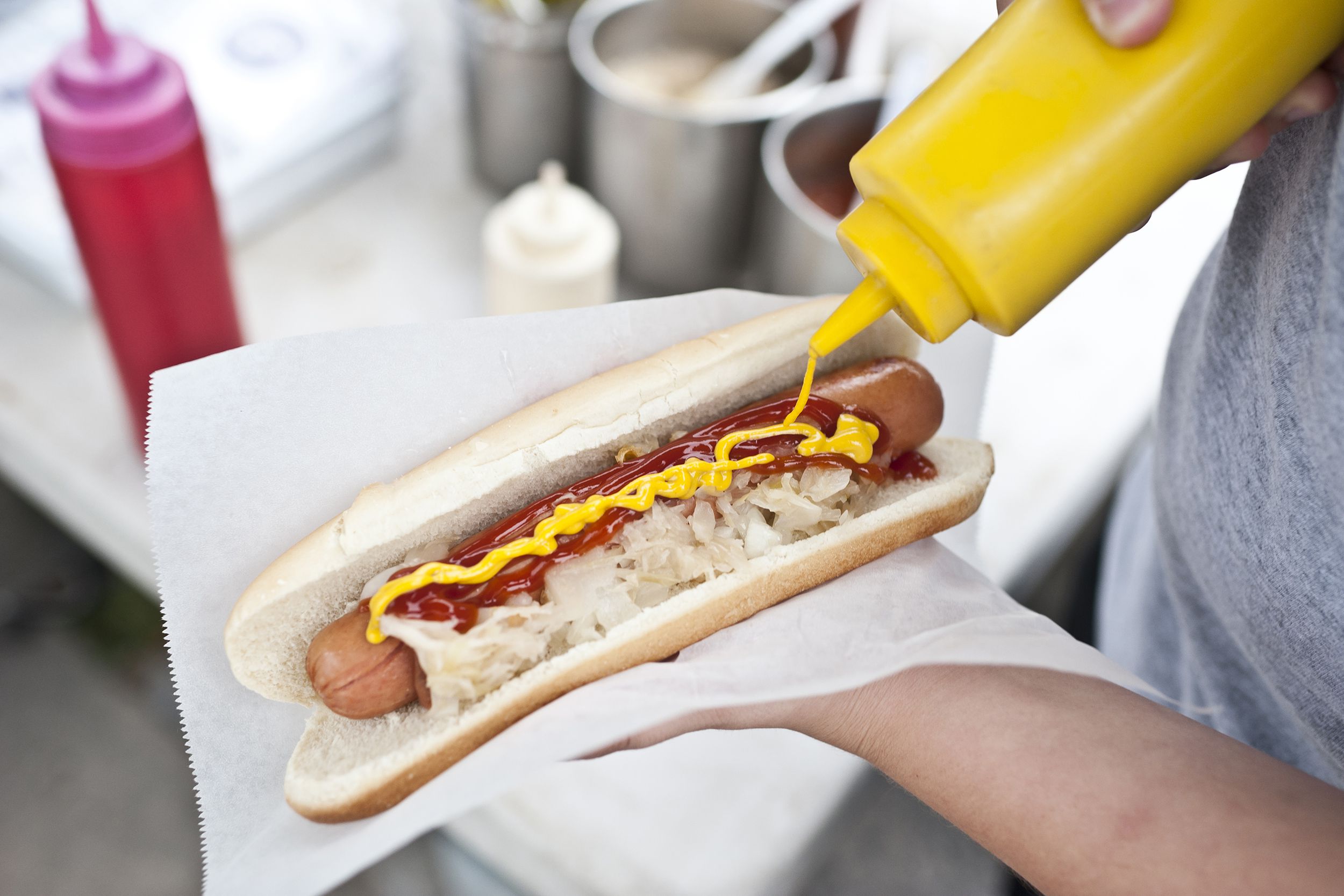 man preparing street hot dog