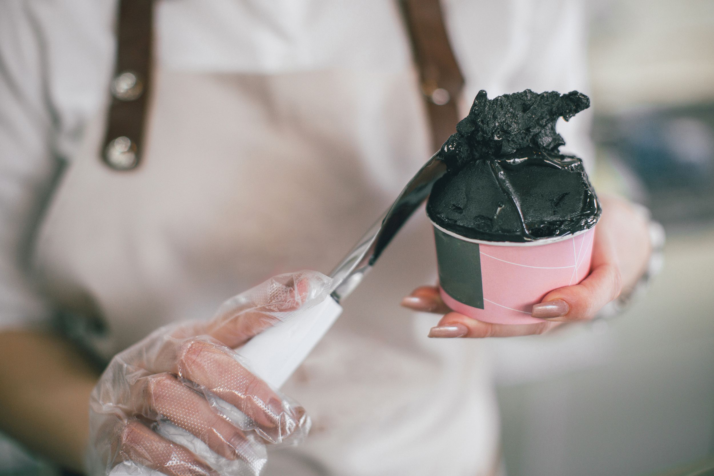person preparing gelato for customer