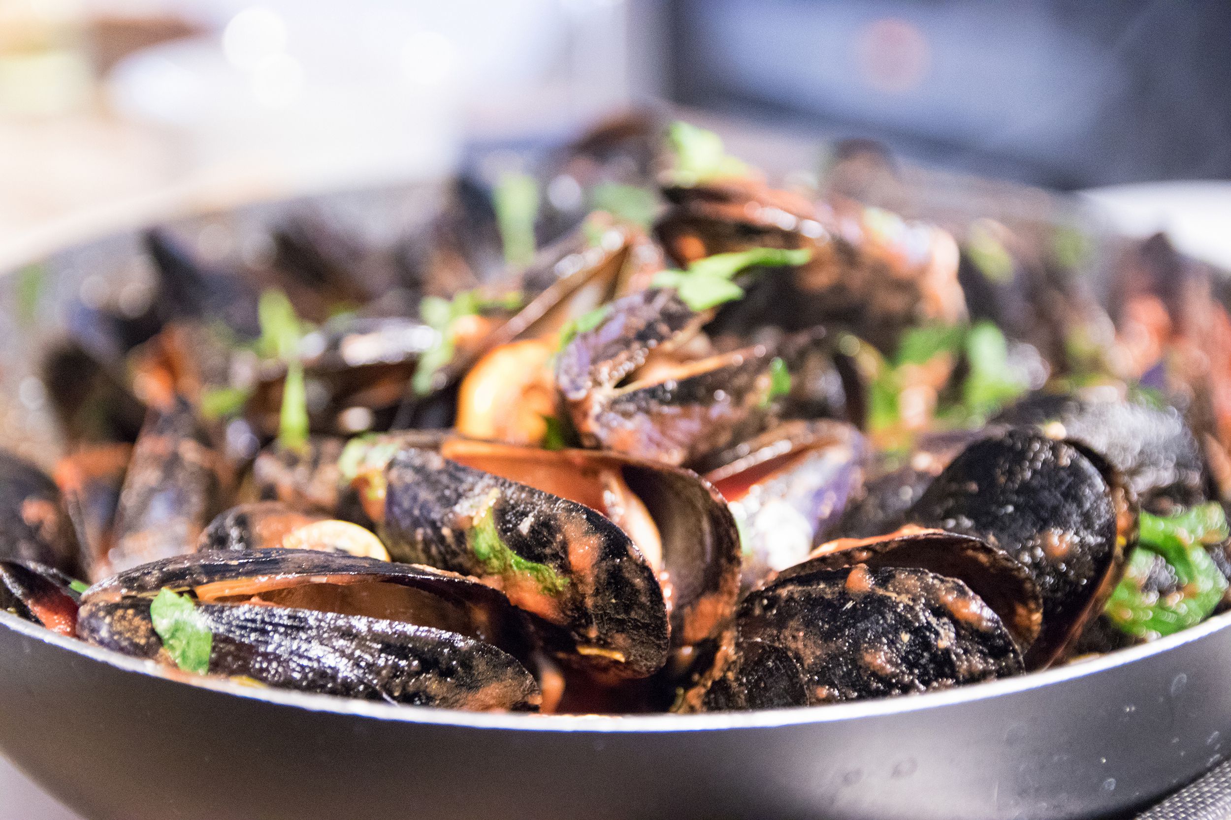 mussels and shrimps in tomato sauce garnished with parsley