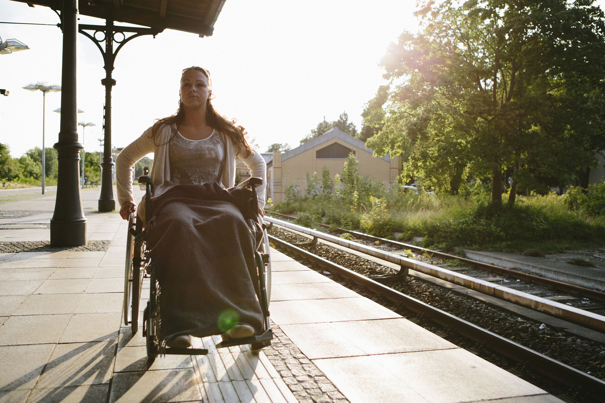 disabled young woman in wheelchair at the train station in Berlin
