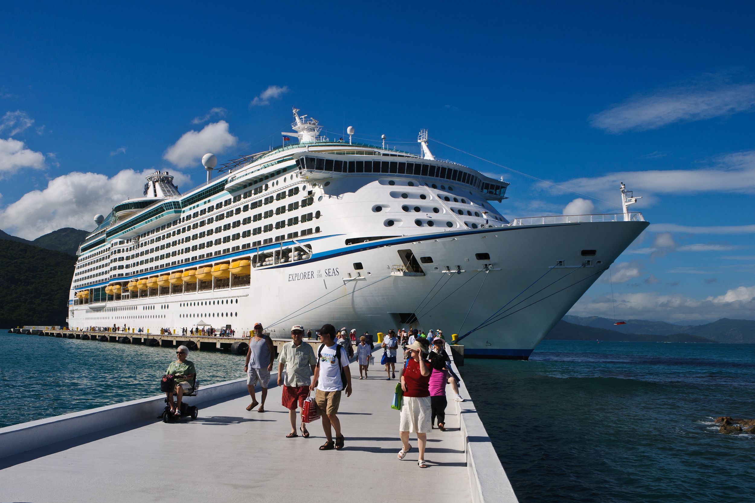 people getting off cruise ship with one person in wheelchair