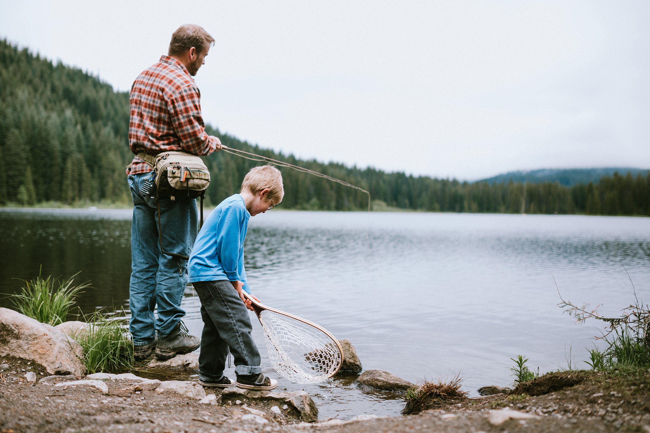 father fly fishing with son