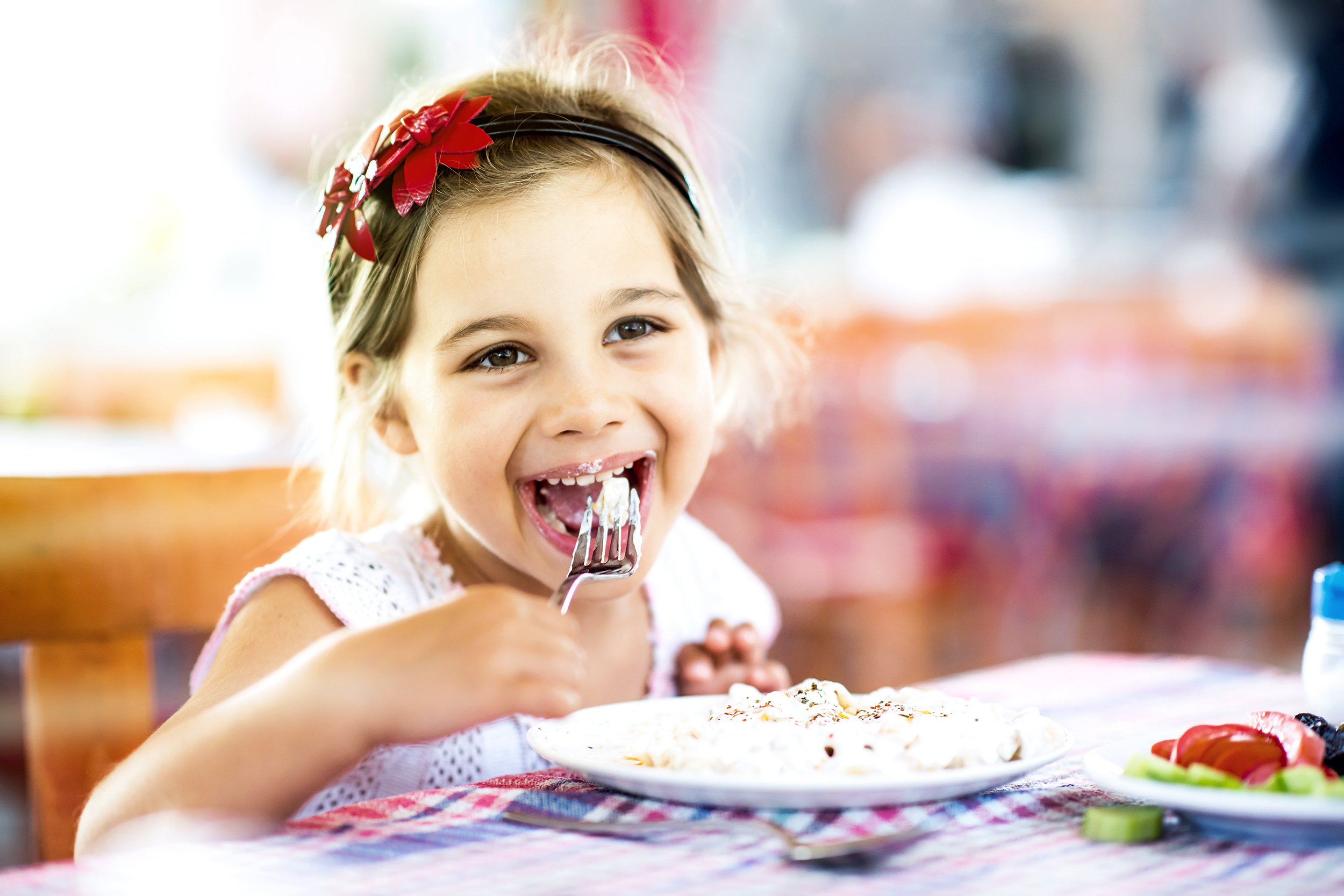 little girl having her meal with pleasure