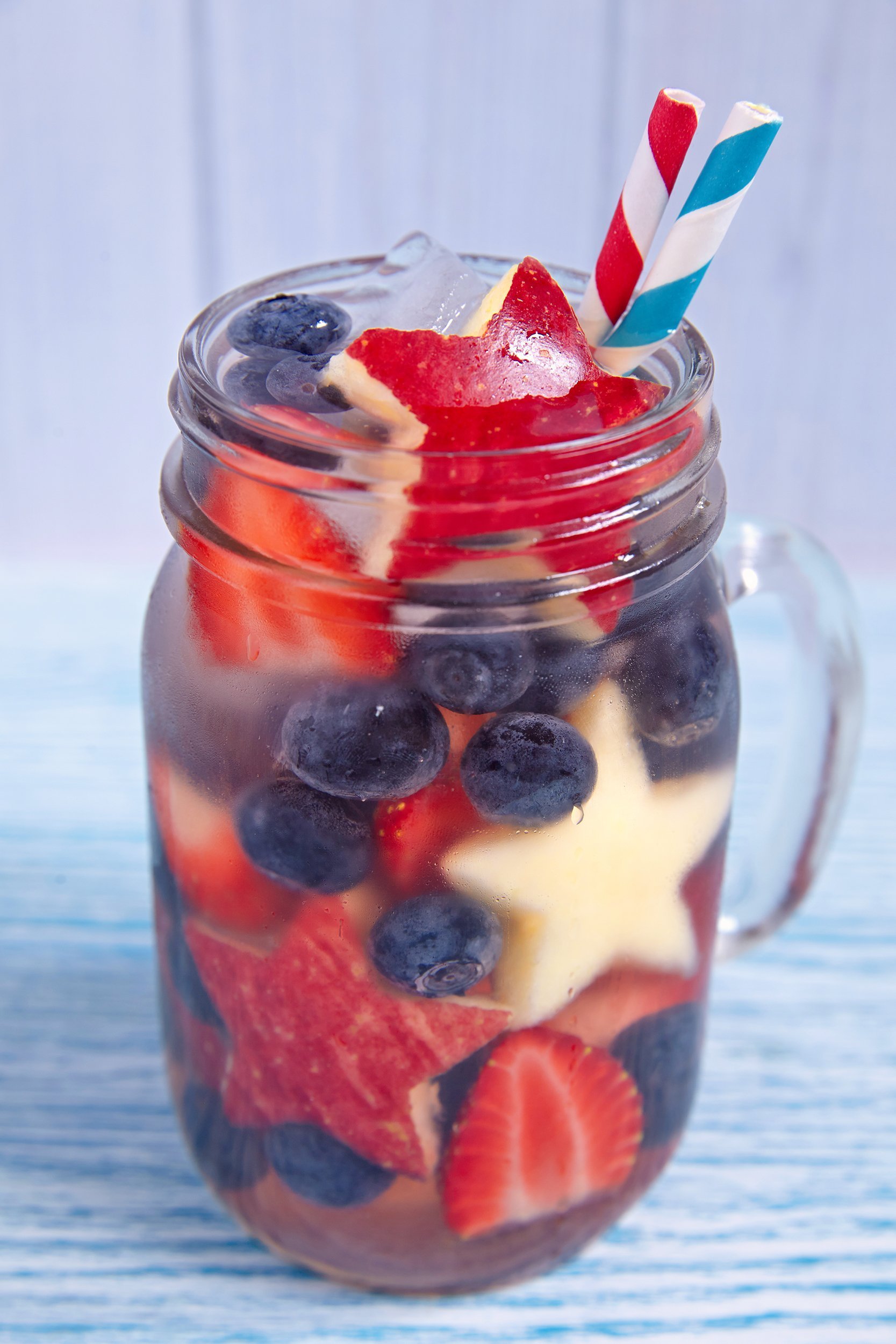 patriotic drink cocktail with strawberry, blueberry, and apple