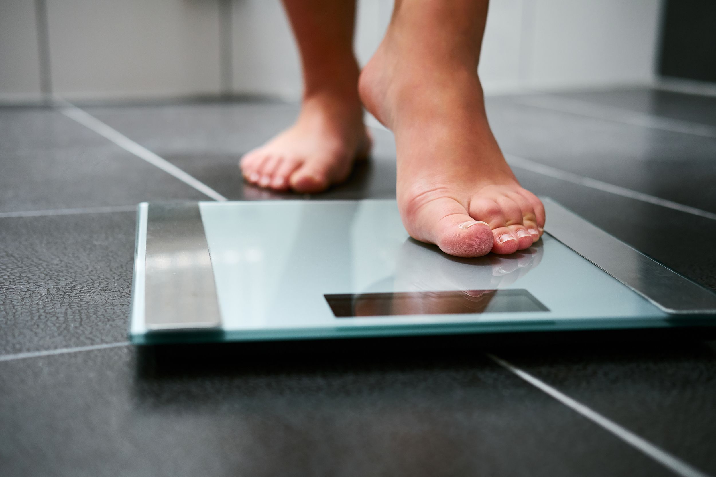 feet stepping on scale