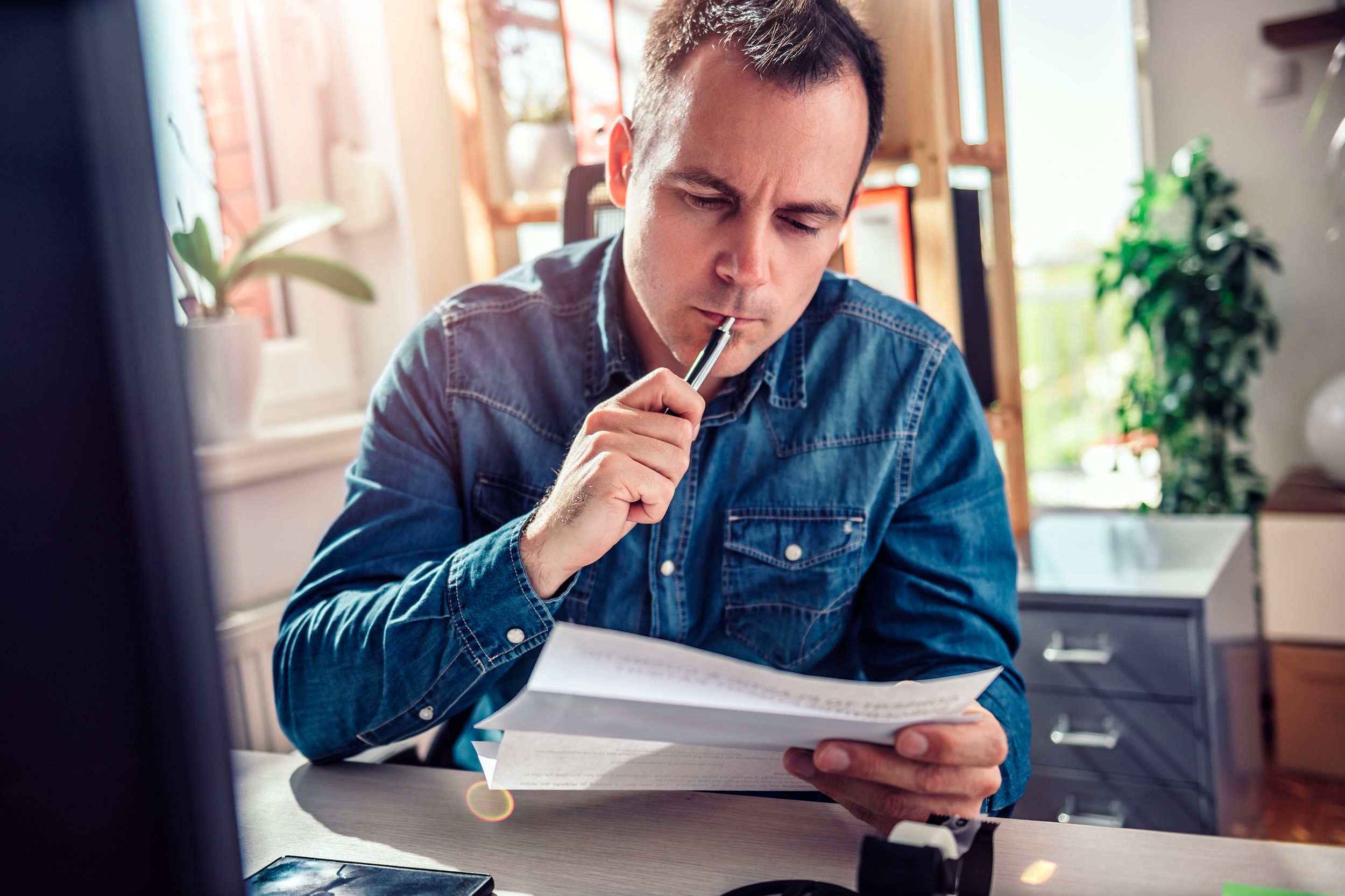 worried businessman reading mail at office