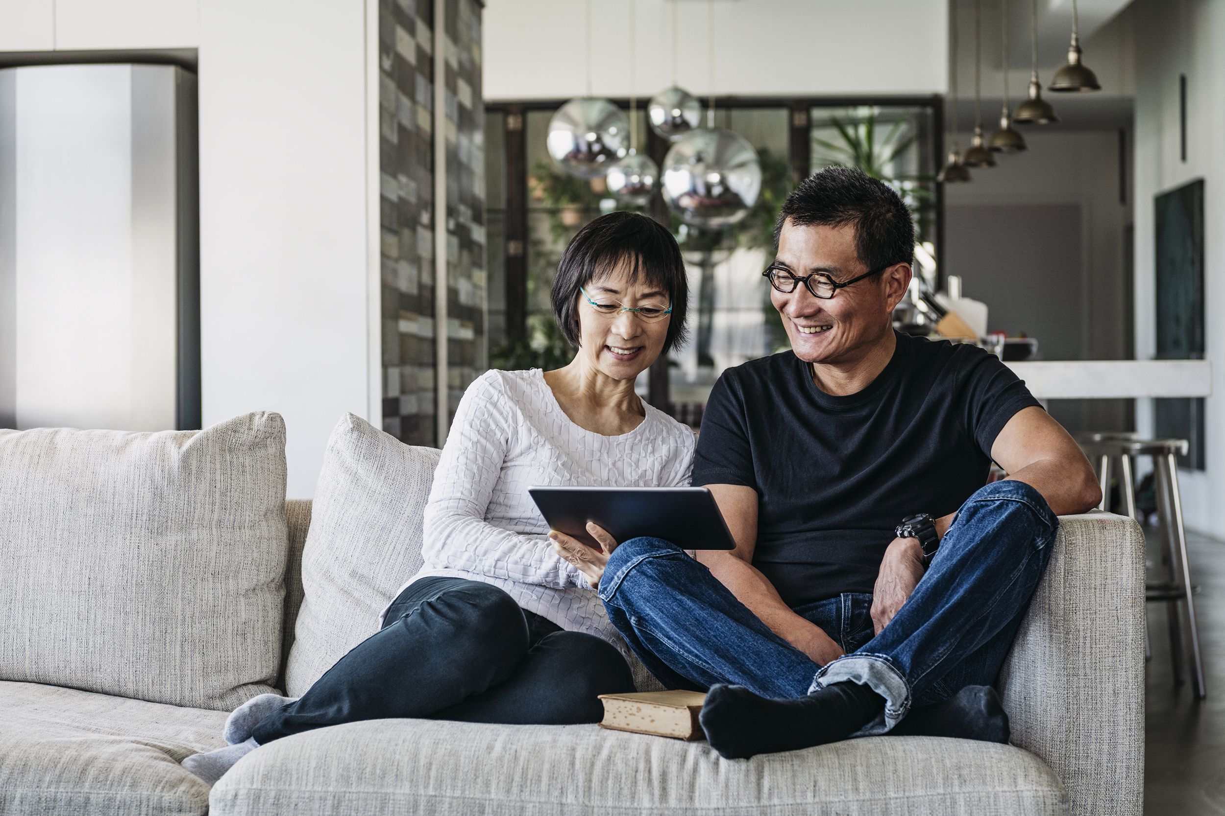 Chinese couple on sofa watching movie online