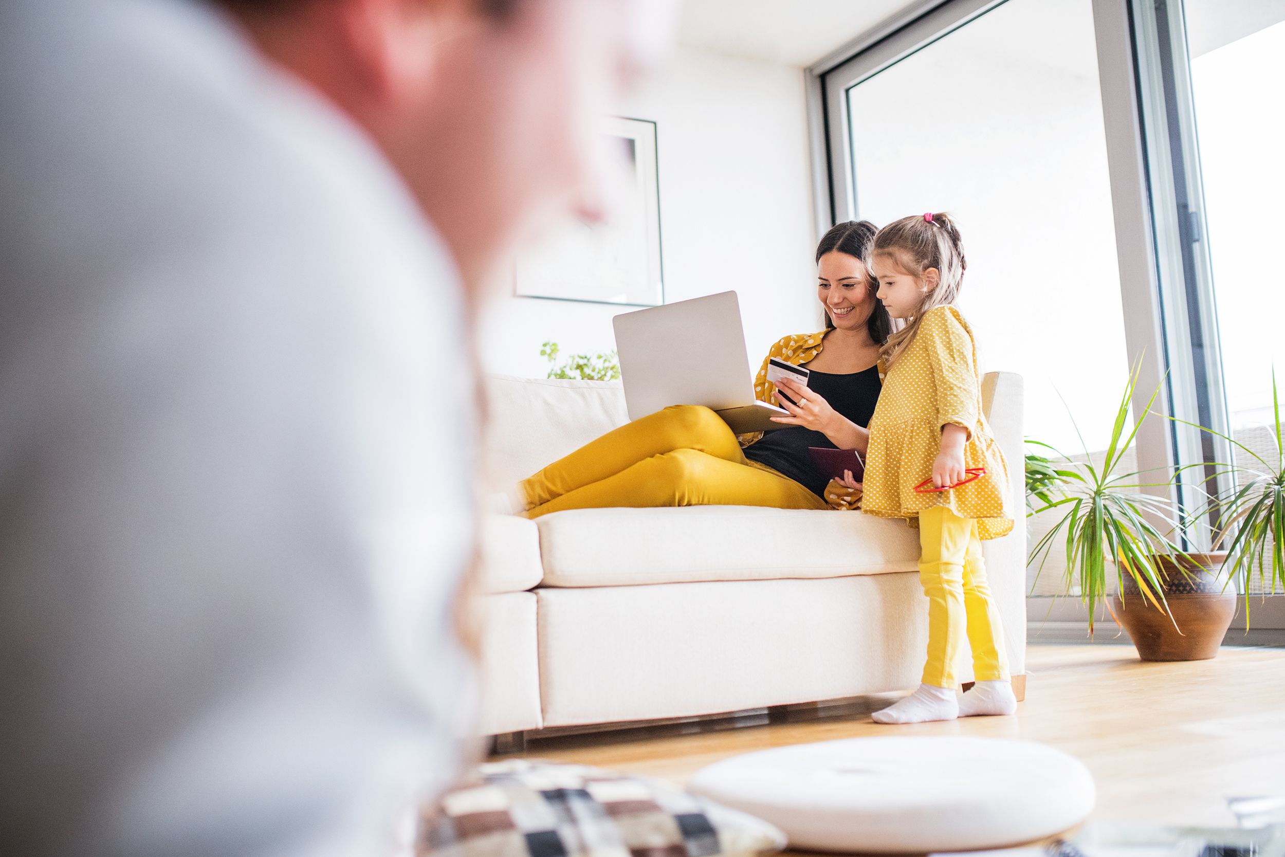 young family with laptop at home preparing for summer holiday