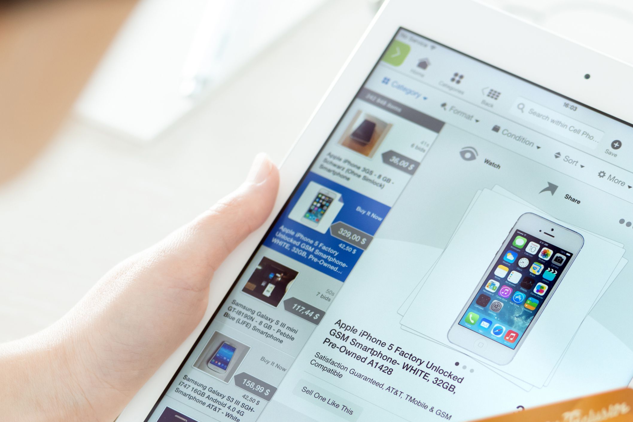person buying on eBay with Apple iPad Air