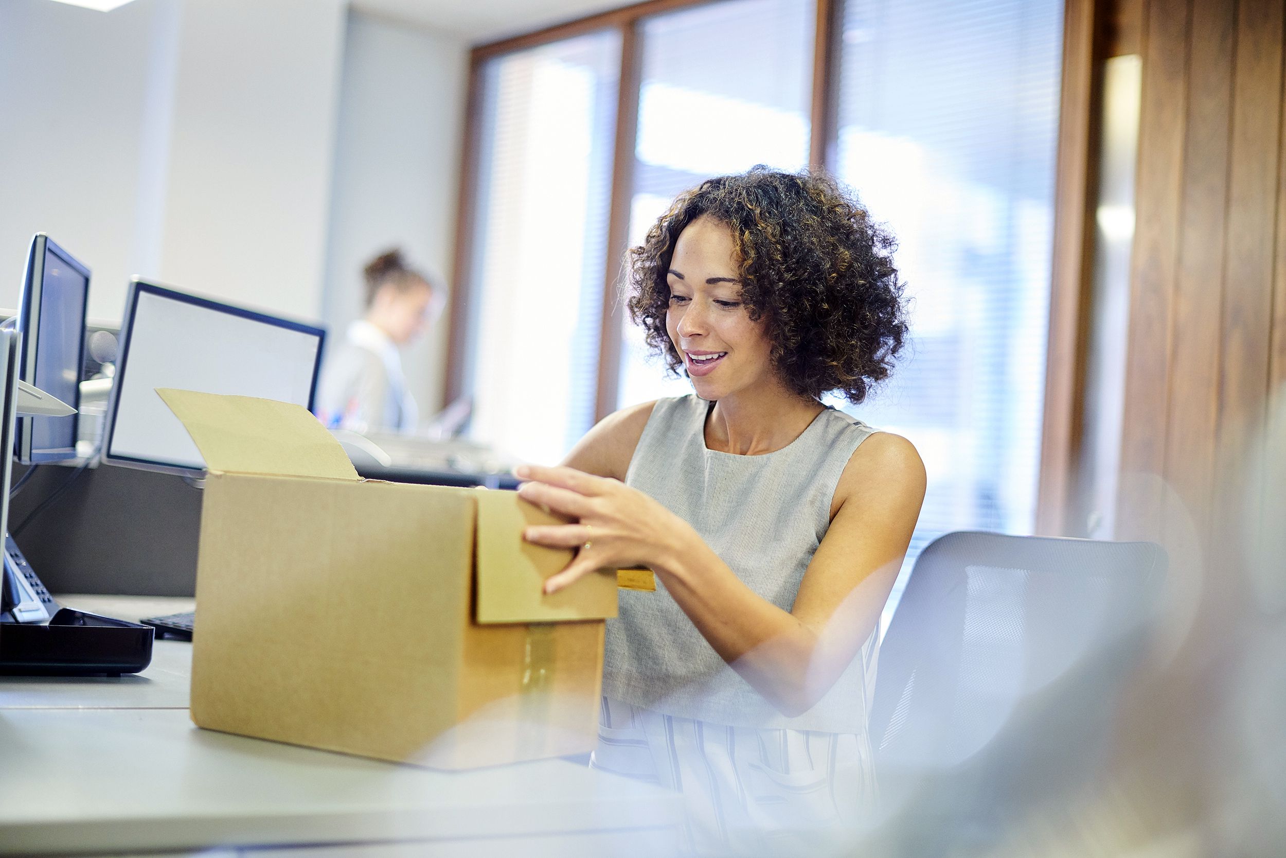 business woman opening box at work