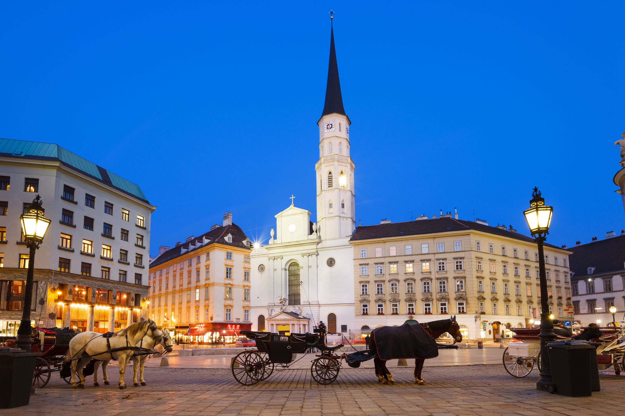 vienna, austria at dusk with horse carriages