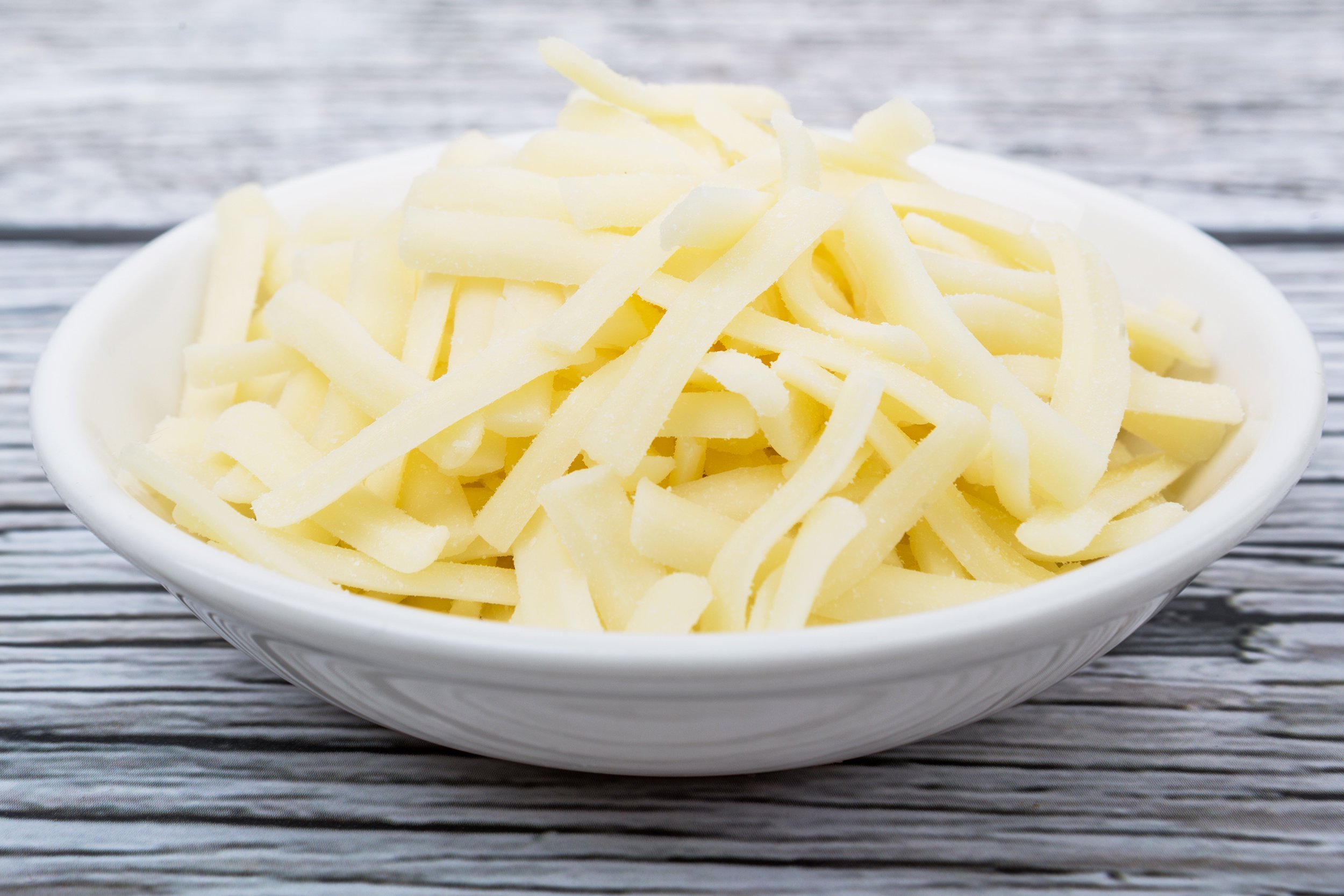 shredded Mozzarella in white bowl