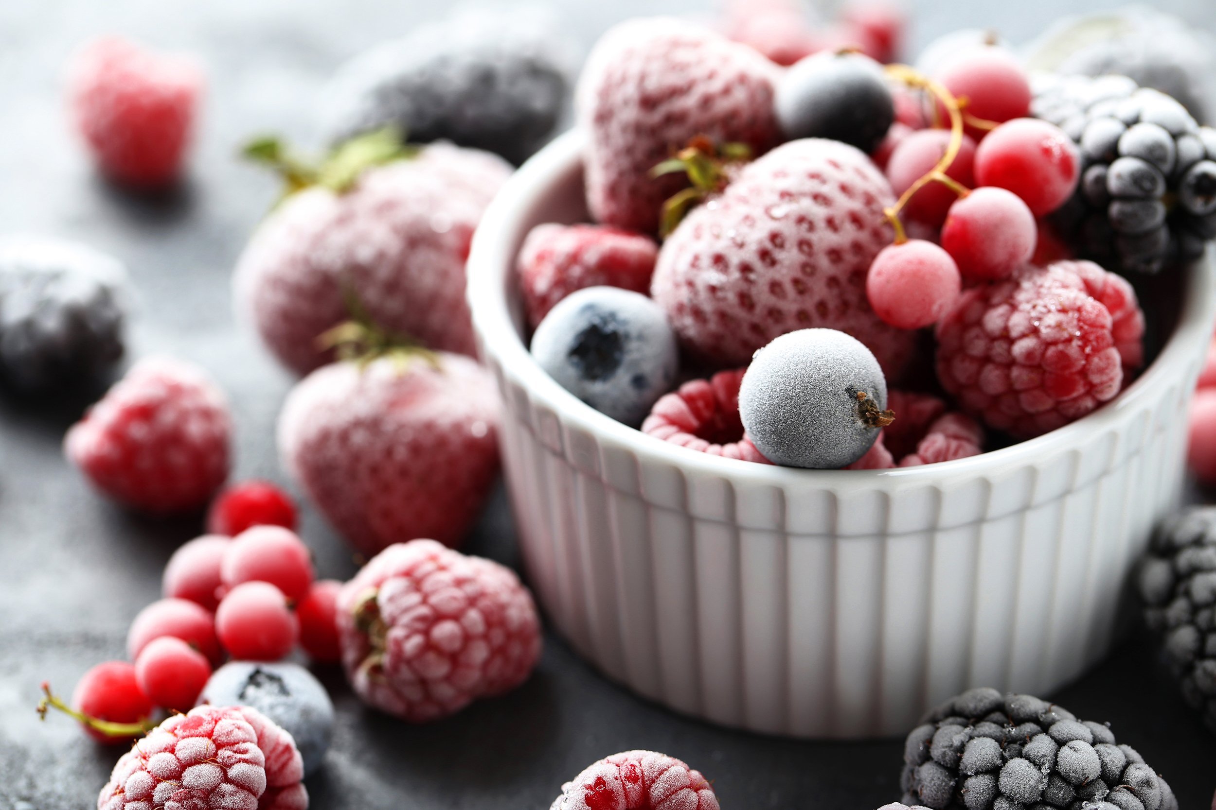 frozen mixed berries on a black wooden table