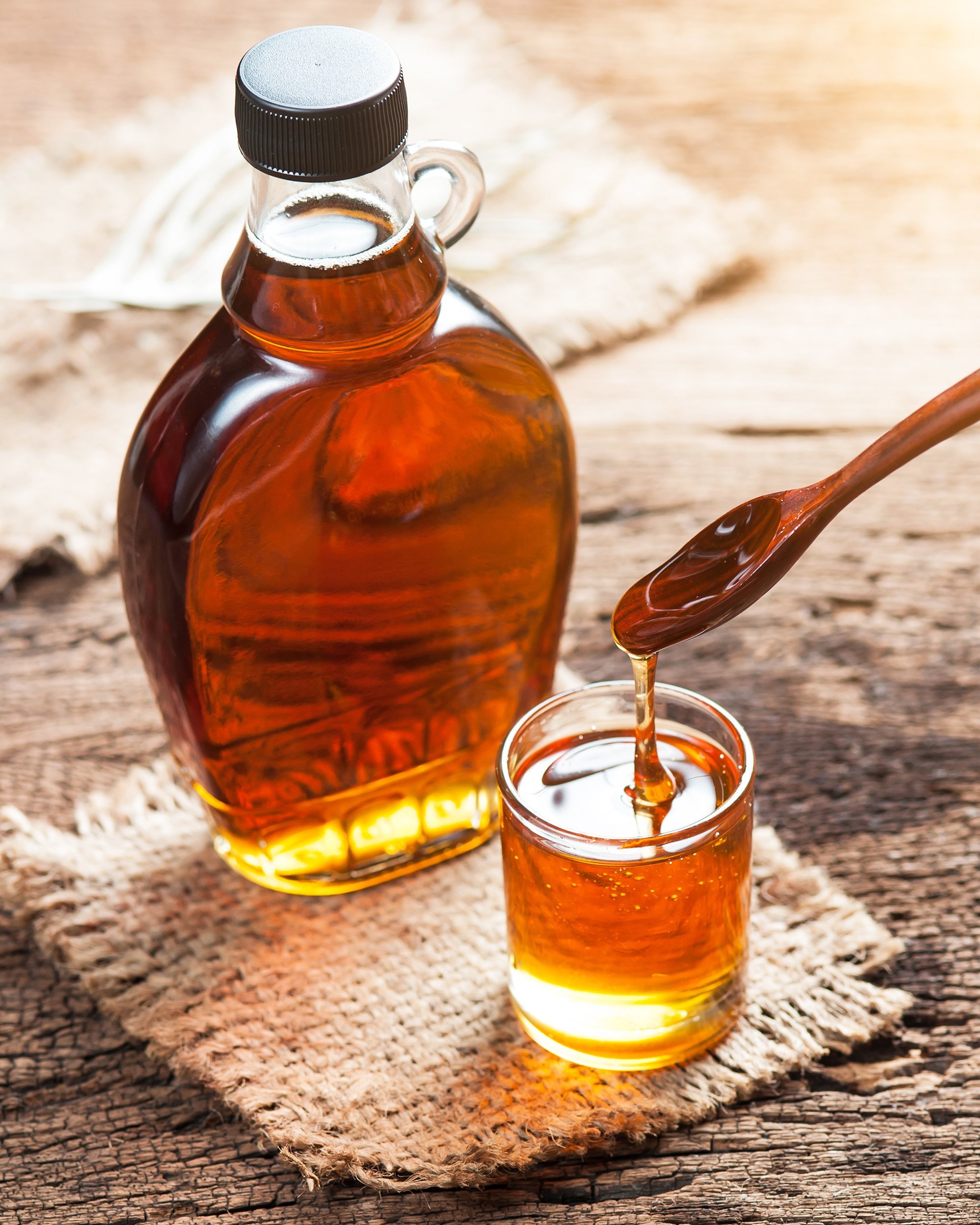 maple syrup in glass bottle on wooden table