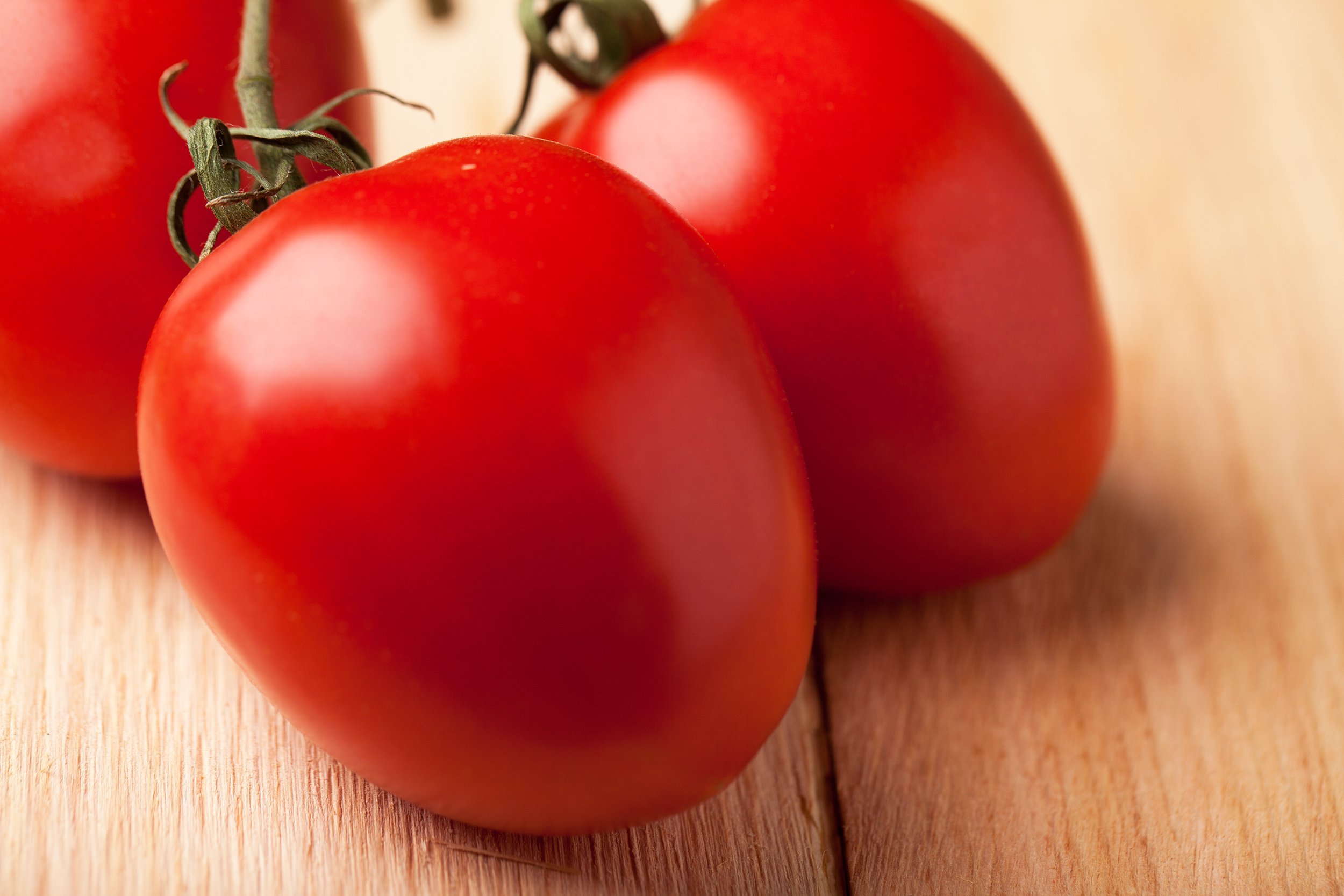 roma tomatoes on the vine on cedar planks