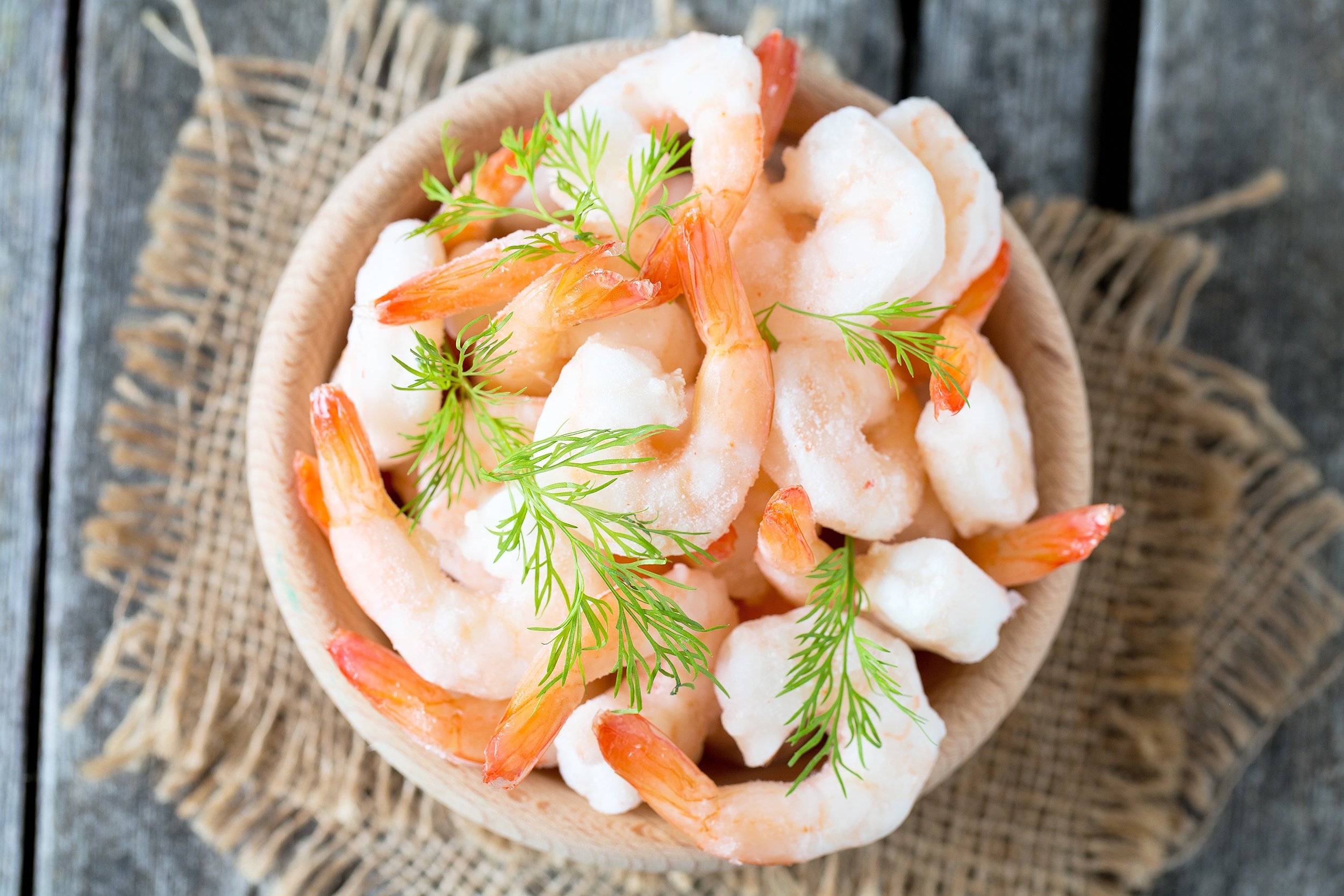 frozen shrimps on wooden surface